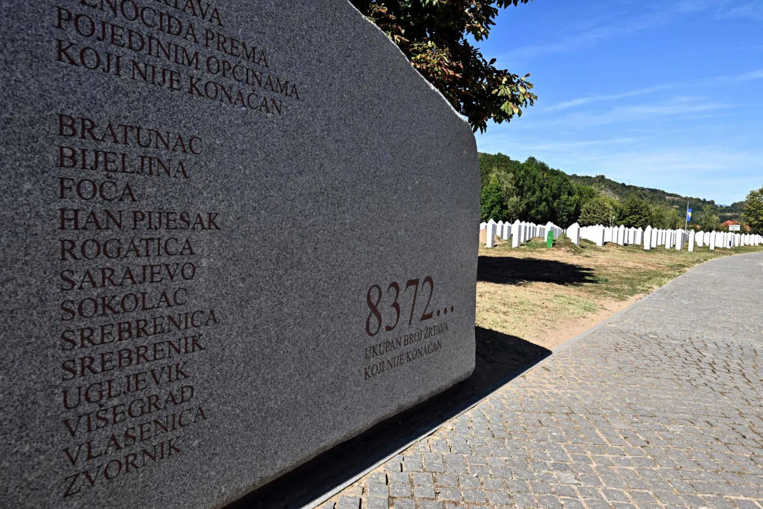 A photograph taken on September 7, 2026 shows a monument reading the figure "8372...", representing the minimum recorded number of victims of the July 1995 Srebrenica massacre at the Srebrenica-Potocari Genocide Memorial and Cemetery in Potocari, near Srebrenica, Bosnia and Herzegovina. (AFP)