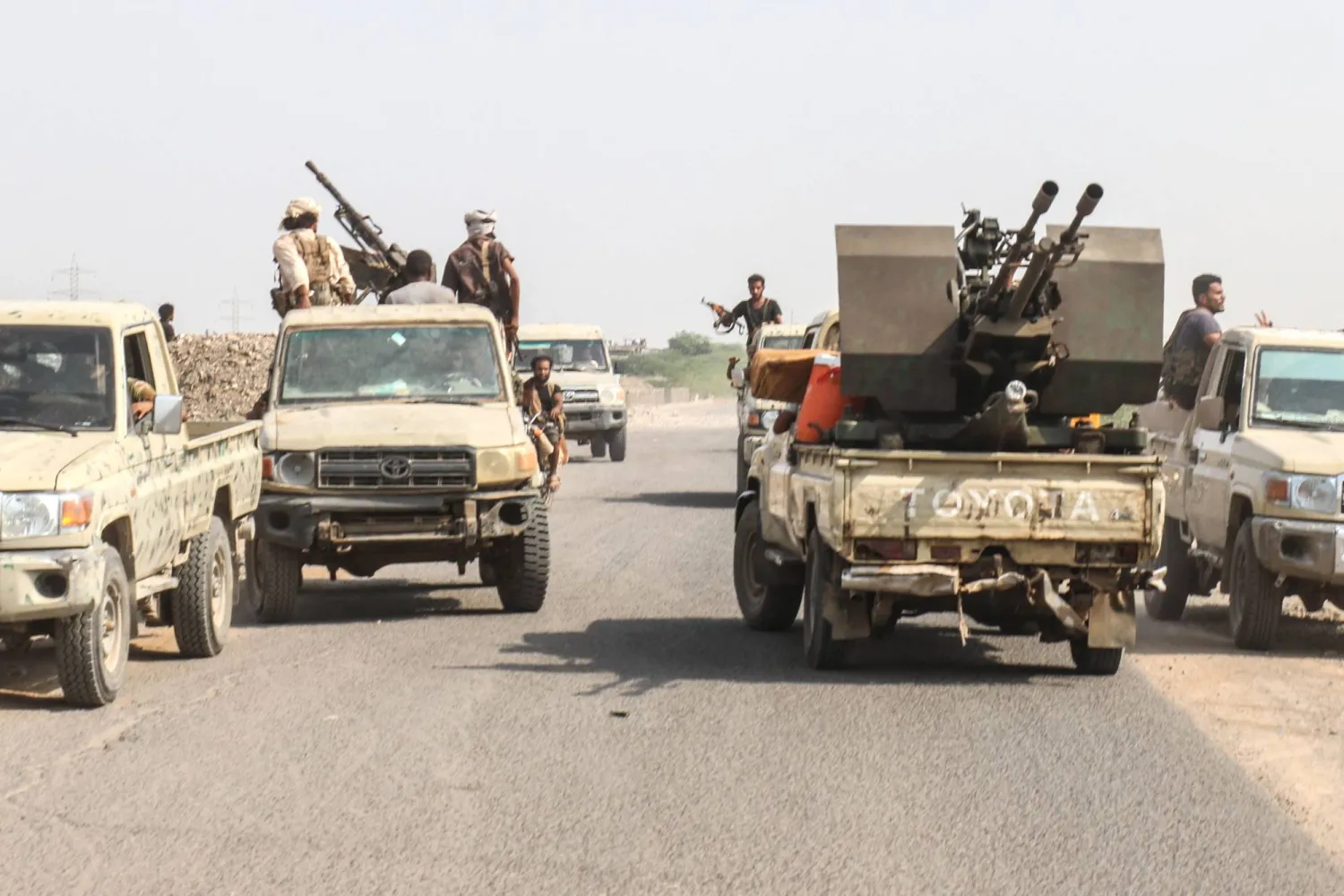 Forces loyal Yemen's legitimate government ride in pick-up trucks along a road in the Hays district, south of Hodeidah on September 5, 2026. (AFP)