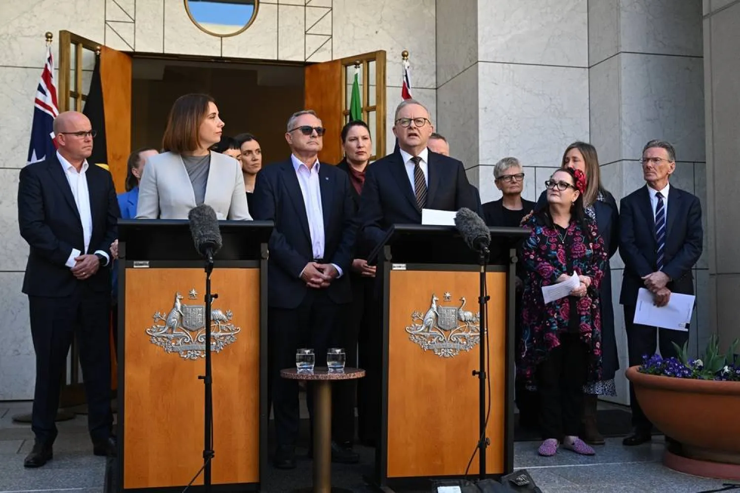 Australian Prime Minister Anthony Albanese (C-R) and Australian Communications Minister Anika Wells (C-L) speak to the media while surrounded by advocates during a press conference at Parliament House in Canberra, Australia, 08 September 2026. (EPA) 
