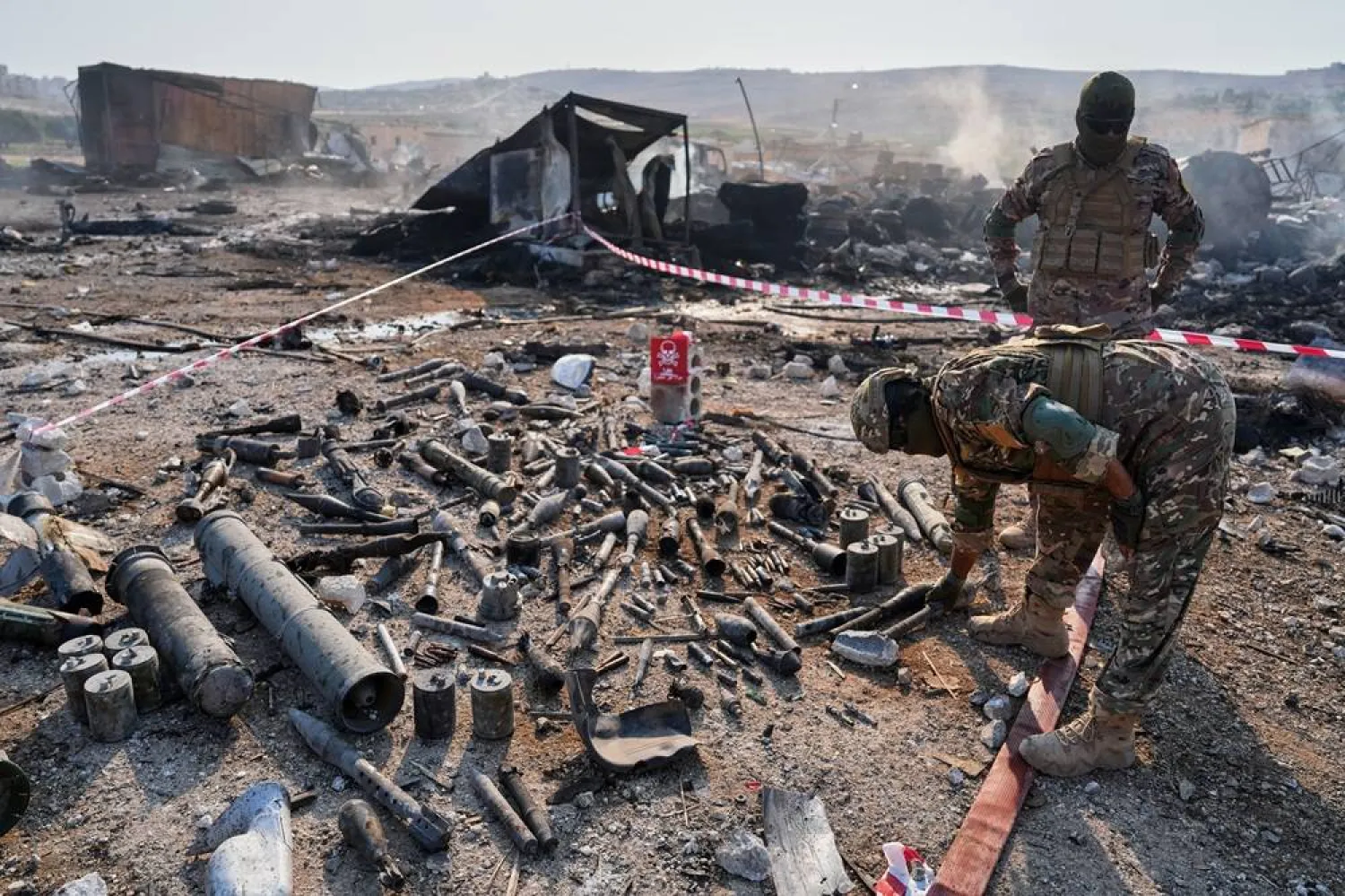 Members of Syria's security forces inspect damaged weapons and munitions at the site of an explosion at what the Defense Ministry said was a warehouse used to store weapons and munitions near Sarmada, in Idlib province, Syria, Wednesday, Sept. 9, 2026. (AP)