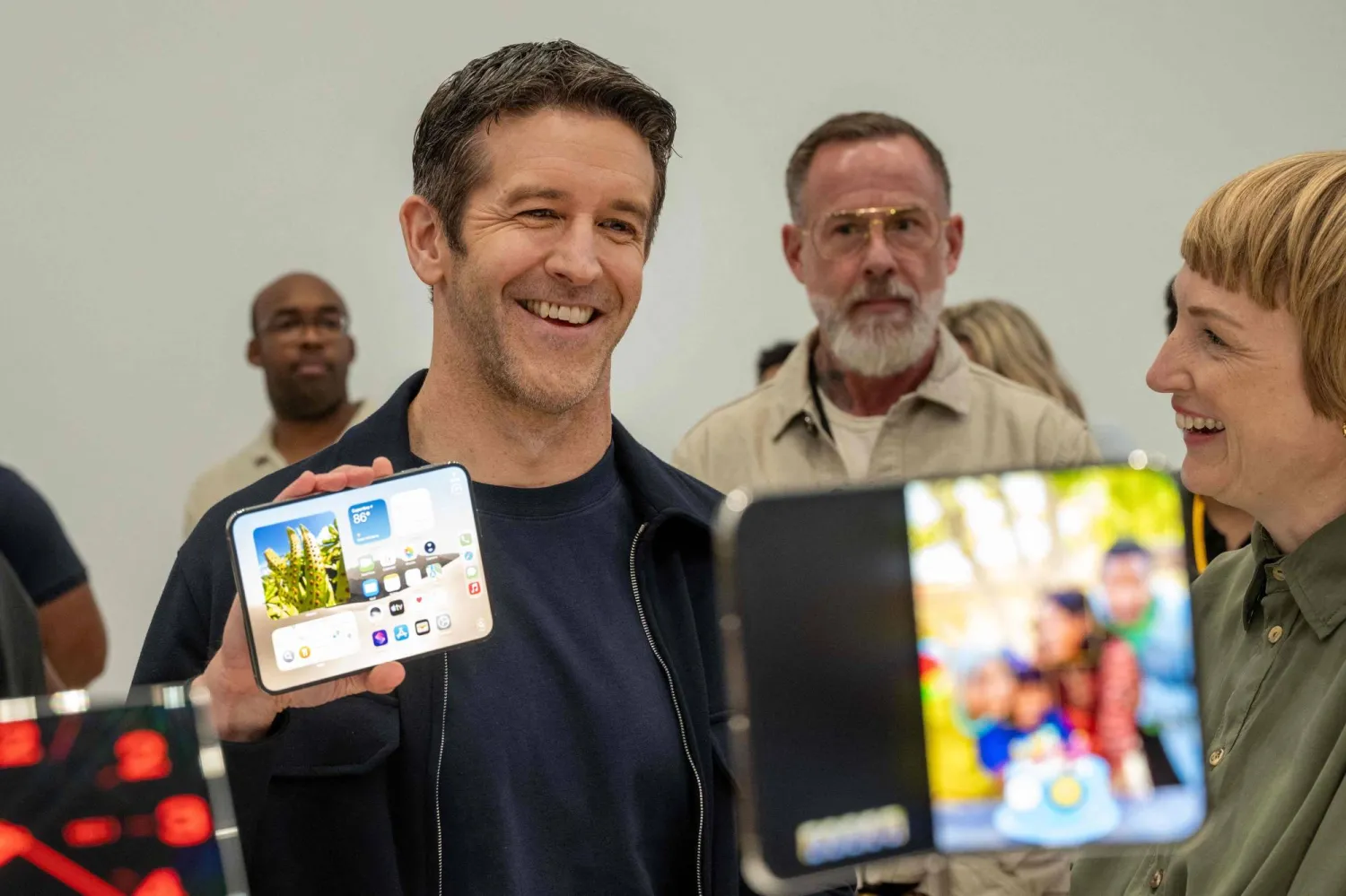 New Apple CEO John Ternus, alongside vice president of industrial Molly Anderson, shows off an iPhone Duo during an Apple event at the Steve Jobs Theater in Apple Park in Cupertino, California, on September 9, 2026. (Photo by Karl Mondon / AFP)