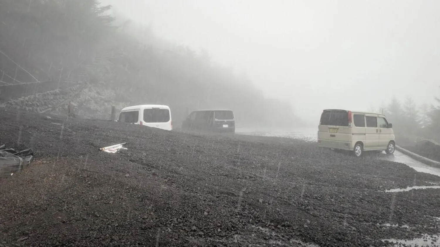 Vehicles buried by mud and debris after a landslide swept into the parking lot at Fifth Station of Mount Fuji's Fujinomiya Trail. Shizuoka Prefecture/AFP
