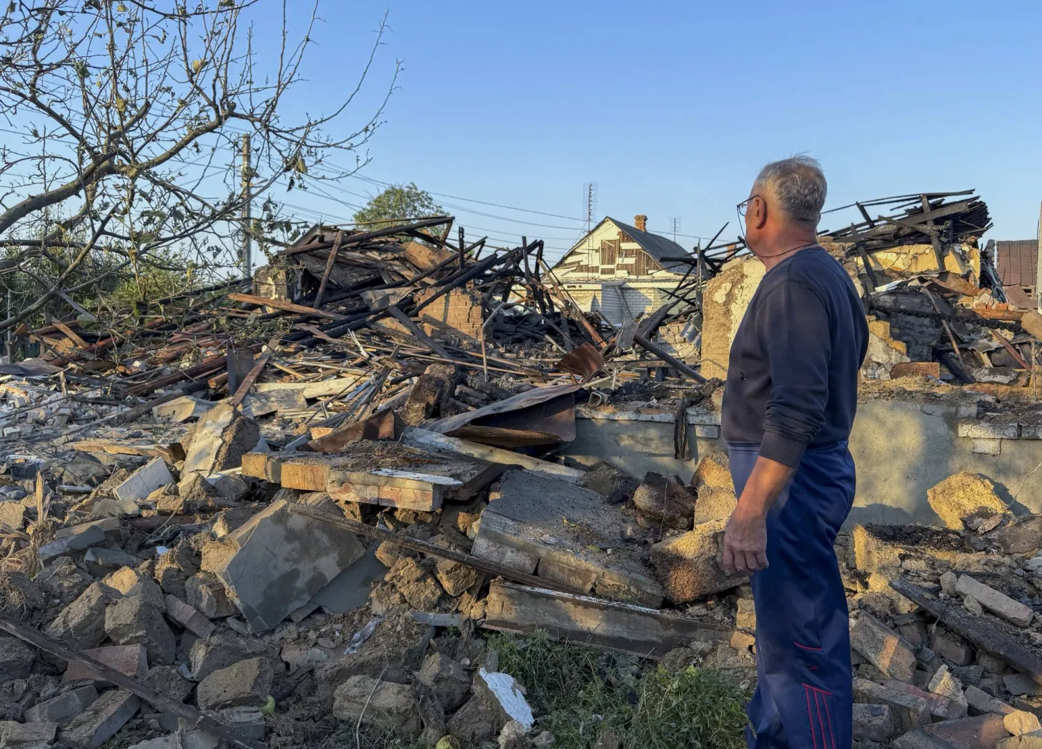 A person inspects the damage at the site of a Russian strike on a building in Zaporizhzhia, Ukraine, 12 September 2026. (EPA)