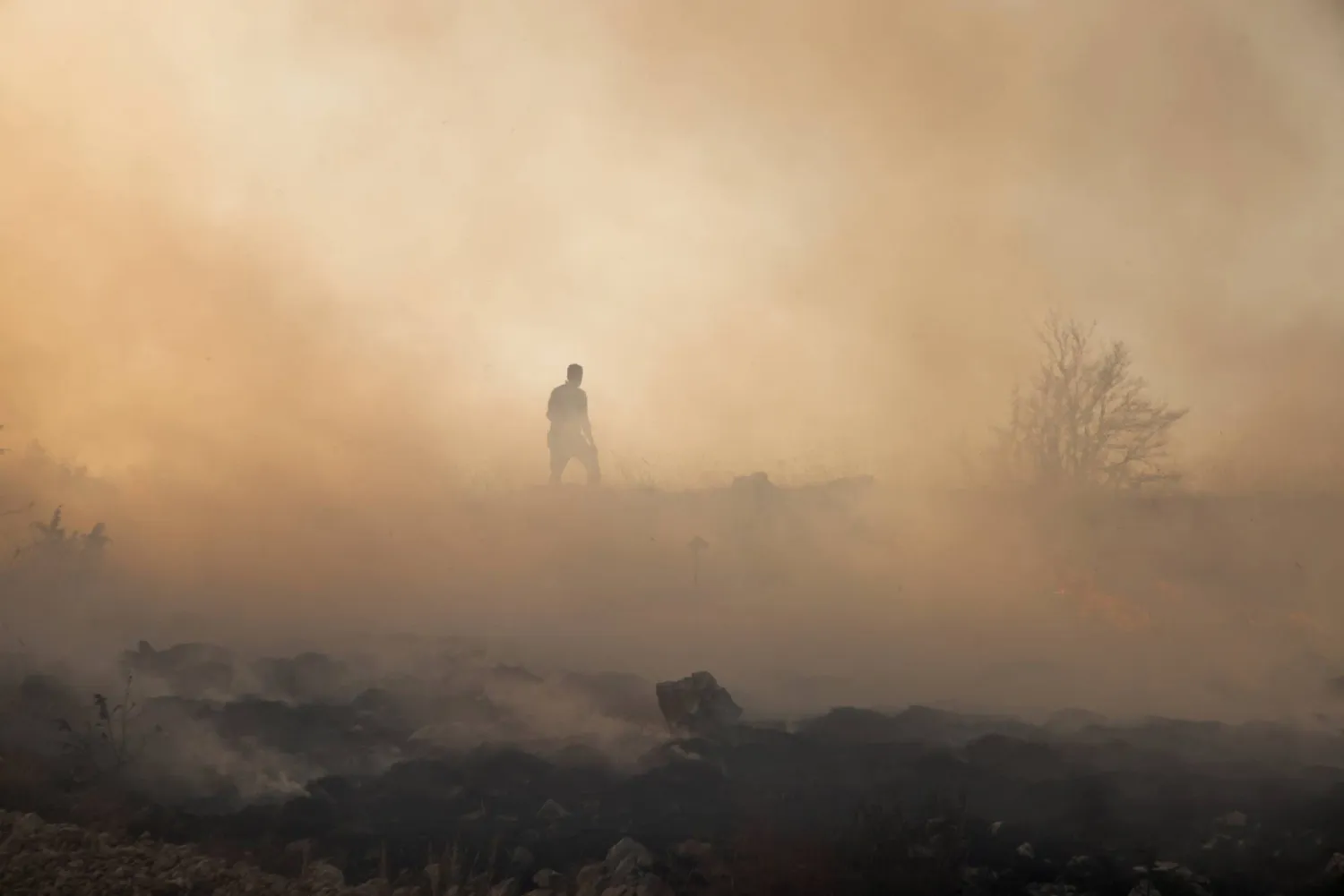 A firefighter inspects the area of a forest fire in Trebisevo, Bosnia and Herzegovina, September 7, 2026. (Reuters)