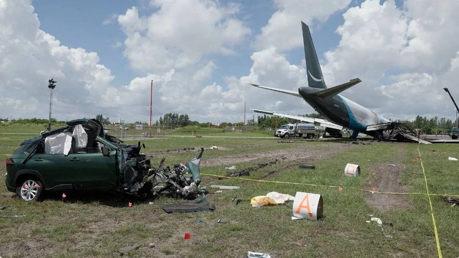 FILE PHOTO: A damaged car next to the wreckage of an Amazon Prime Air cargo plane overran a runway at Miami International Airport, in Miami, Florida, US, in this screengrab obtained from a handout video released on September 8, 2026. National Transportation Safety Board/Handout via REUTERS