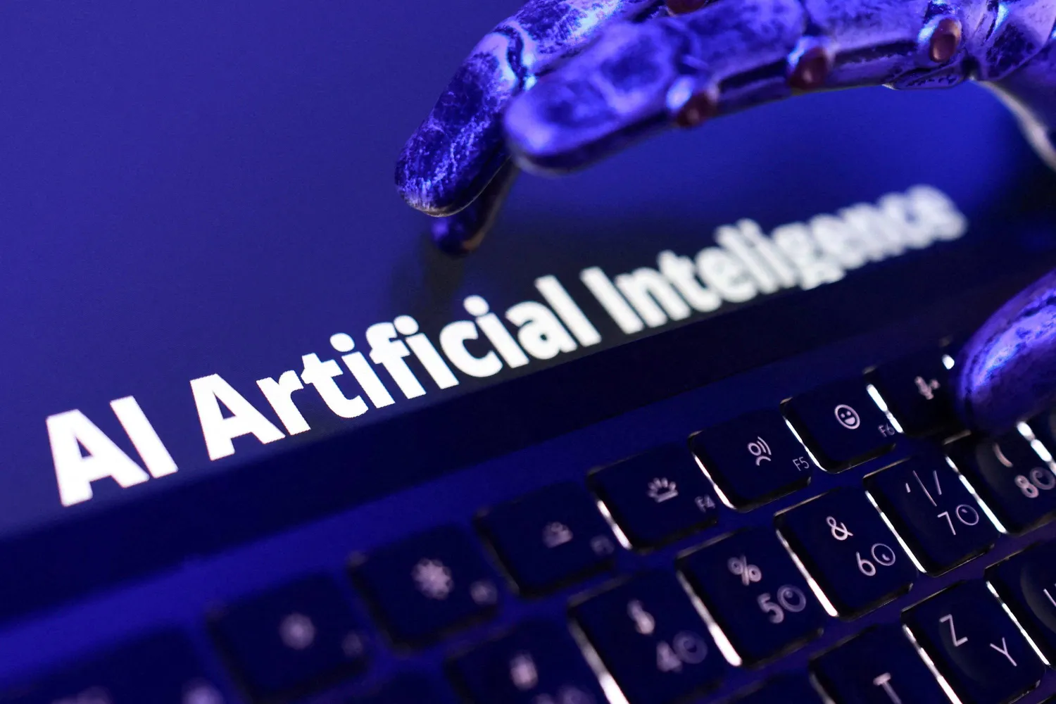Words "AI Artificial Intelligence", keyboard, and a robotic hand in this illustration taken June 5, 2026. (Reuters)