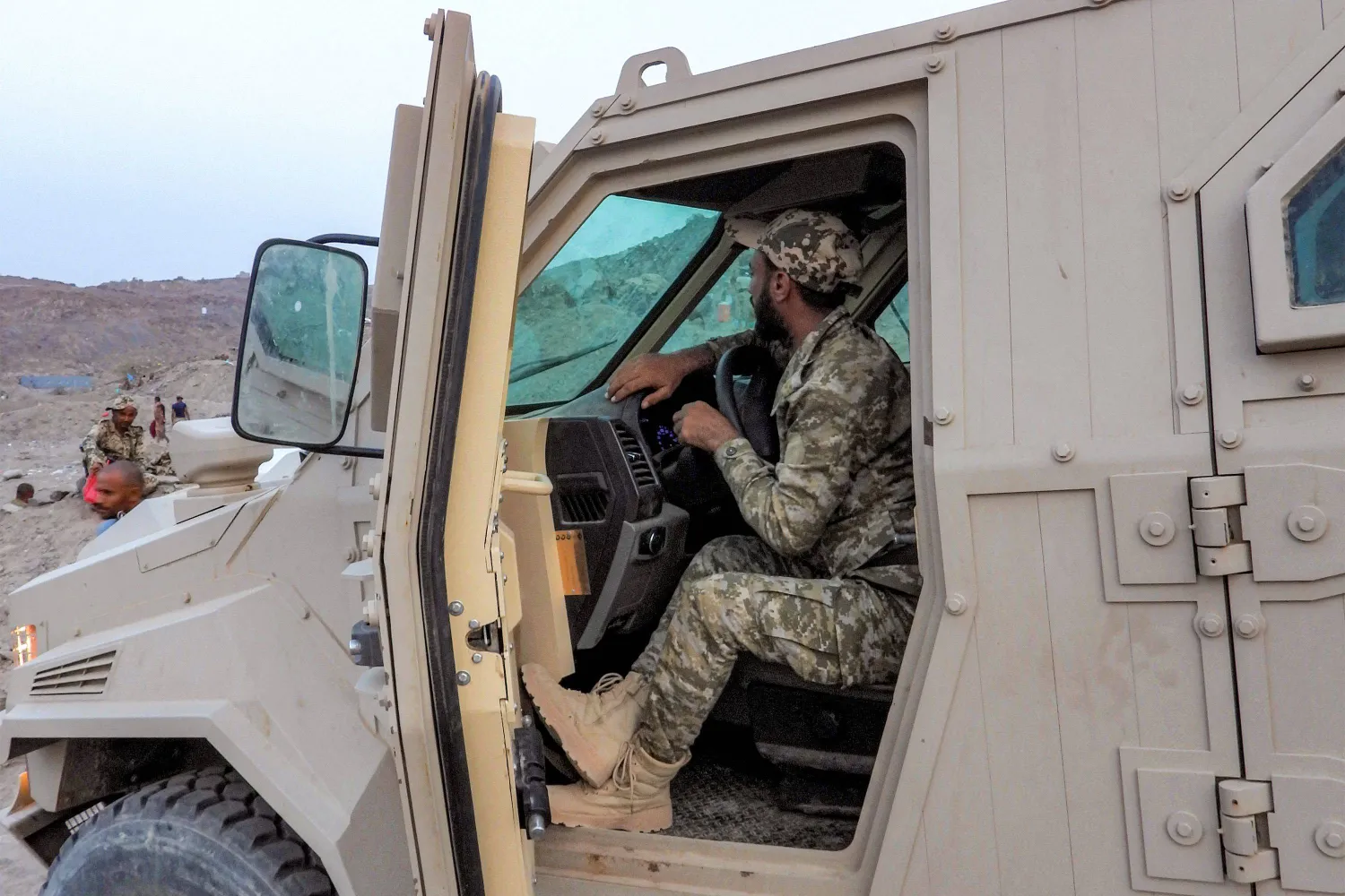 A member of the Yemeni government forces, including National Army and Taiz Axis forces, sits in an armored vehicle at a position along the Kadha frontline west of Taiz in western Yemen on September 13, 2026. (AFP)