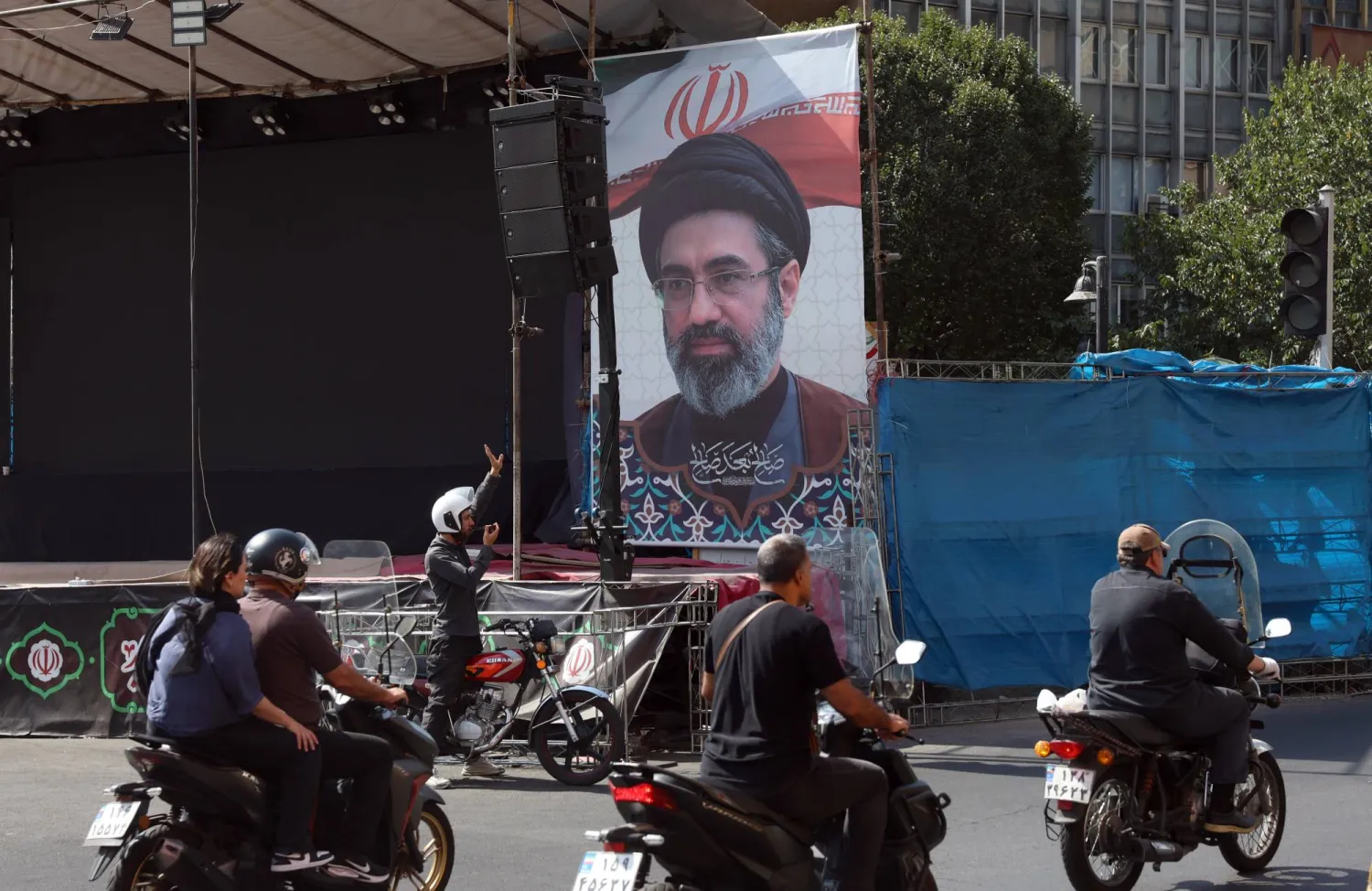 Iranians drive past a billboard of Iranian supreme leader Mojtaba Khamenei in a street in central Tehran, Iran, 13 September 2026. (EPA)