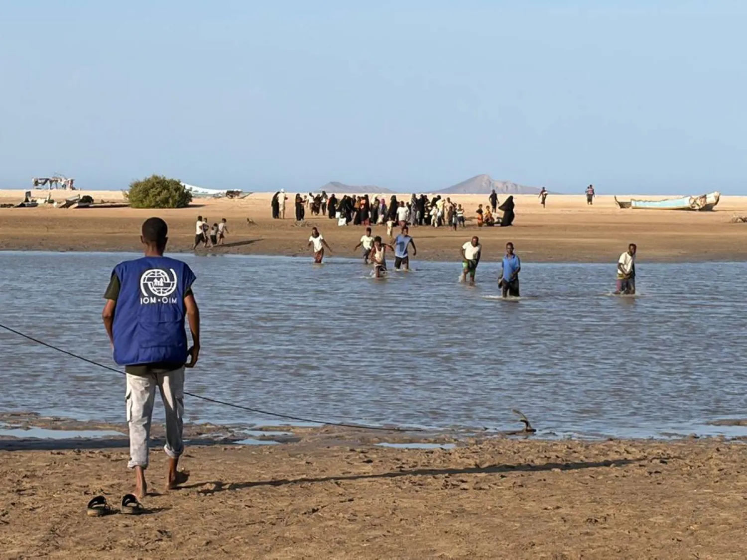 This handout picture taken and released by the International Organization for Migration (IOM) Djibouti shows refugees from Yemen fleeing fighting between government forces and Iran-backed Houthi militants as they arrive at a Djibouti Coast Guard post in Khor Angar on September 13, 2026. (Handout / IOM Djibouti / AFP) 