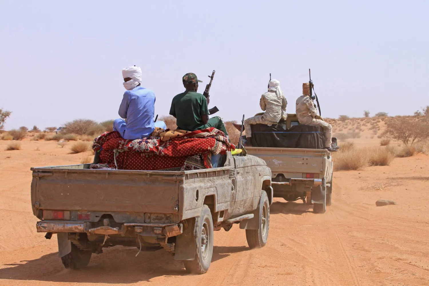A group of armed defectors from the Rapid Support Forces (RSF) arrive in a vehicle as they are believed to be surrendering to the Sudanese military, in the west of Omdurman on August 19, 2026. (Photo by Ebrahim Hamid / AFP)