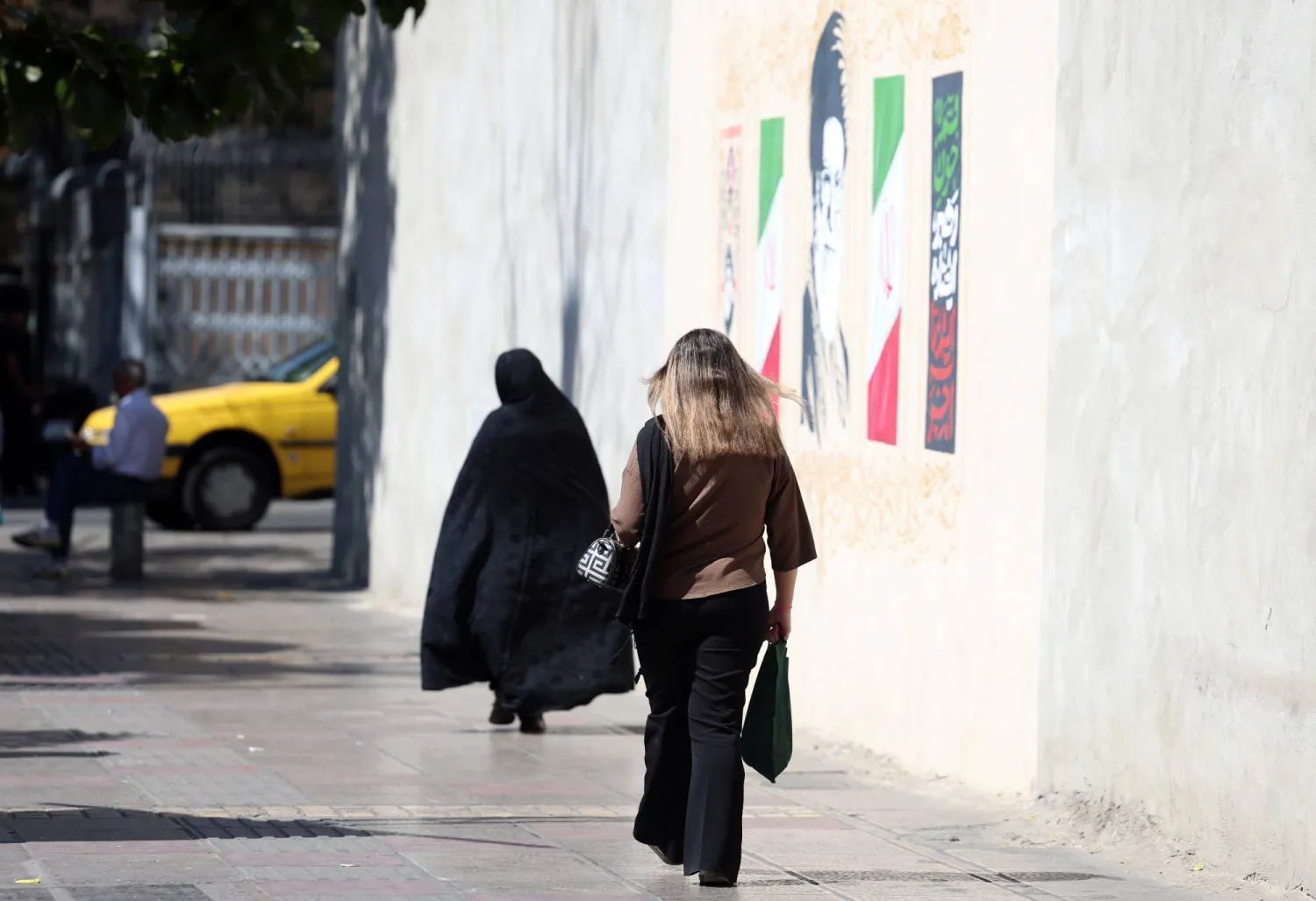 Iranian women walk in a street on the fourth anniversary of protests following Mahsa Amini's death in downtown Tehran, Iran, 16 September 2026. (EPA)