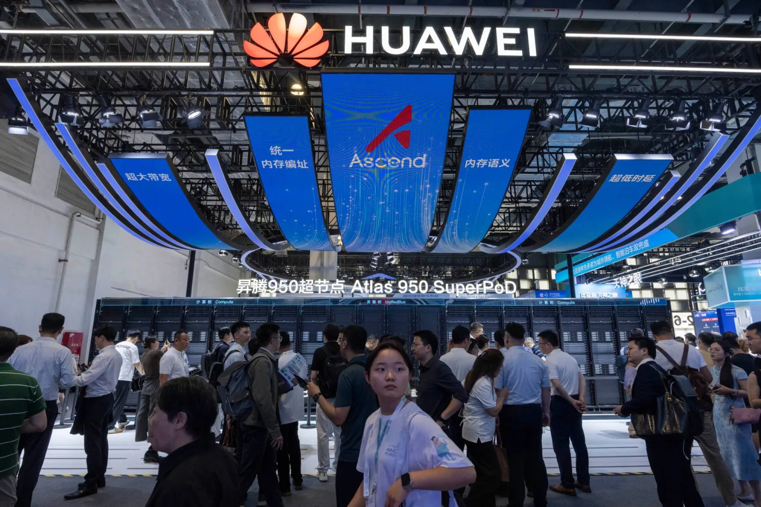 Visitors past by the Huawei booth display of the Atlas 950 SuperPoD during the World AI Conference in Shanghai, China on Friday, July 17, 2026. (AP Photo/Ng Han Guan)