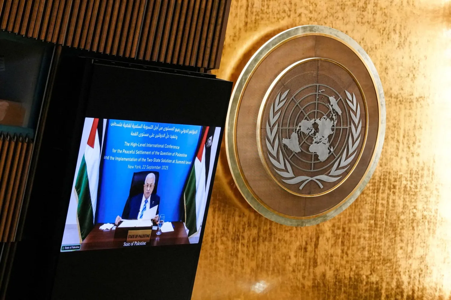 FILE PHOTO: Palestinian President Mahmoud Abbas appears on a screen as he addresses delegates during a high-level meeting of heads of state on a two-state solution between Israel and the Palestinians at United Nations headquarters in New York City, US, September 22, 2025. REUTERS/Eduardo Munoz/File Photo