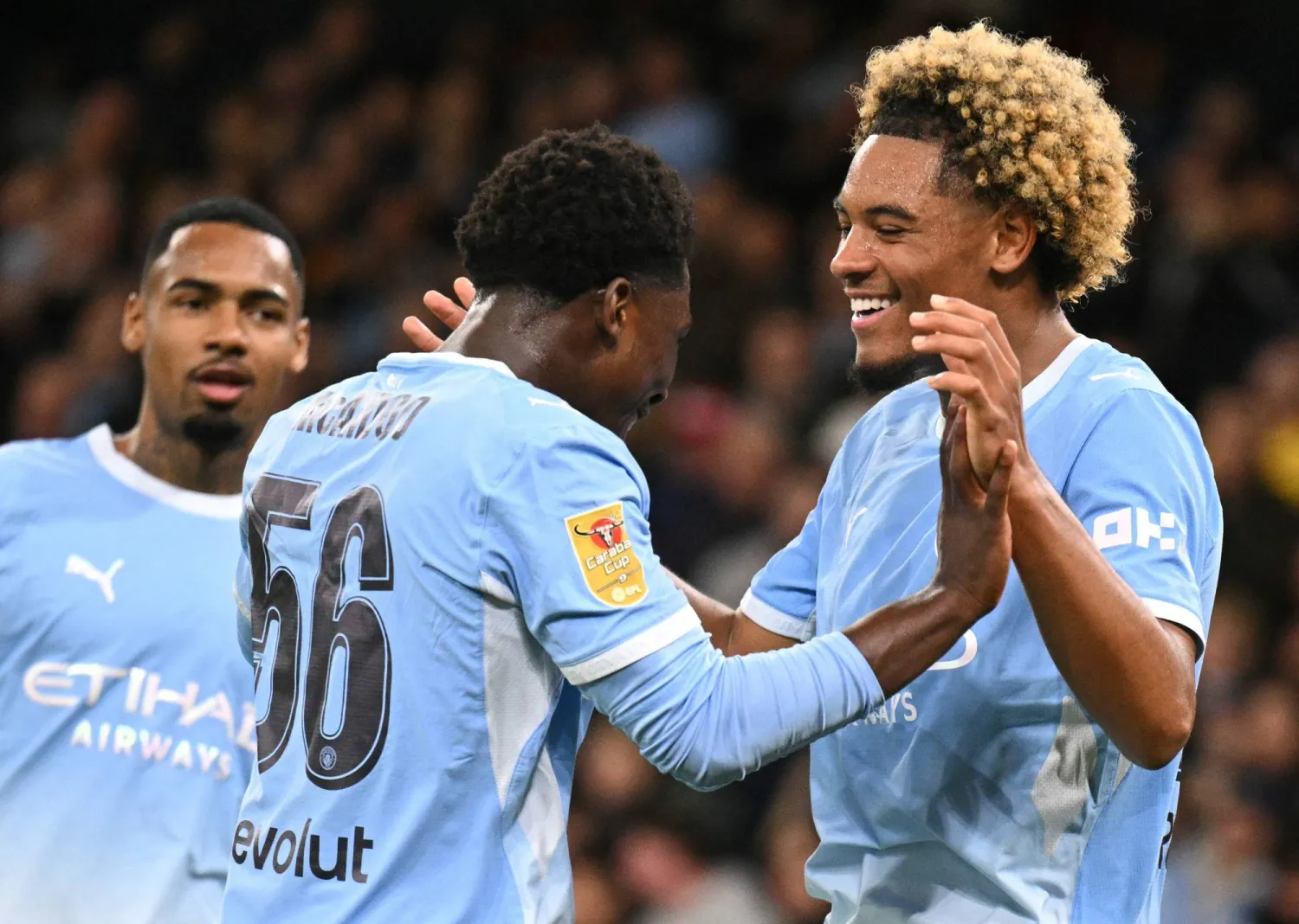 Manchester City's French midfielder #75 Floyd Samba (R) celebrates scoring the team's fourth goal with Manchester City's English midfielder #56 Ryan McAidoo during the English League Cup third round football match between Manchester City and Norwich City at the Etihad stadium in Manchester, northwest England on September 17, 2026. (Photo by Oli SCARFF / AFP)