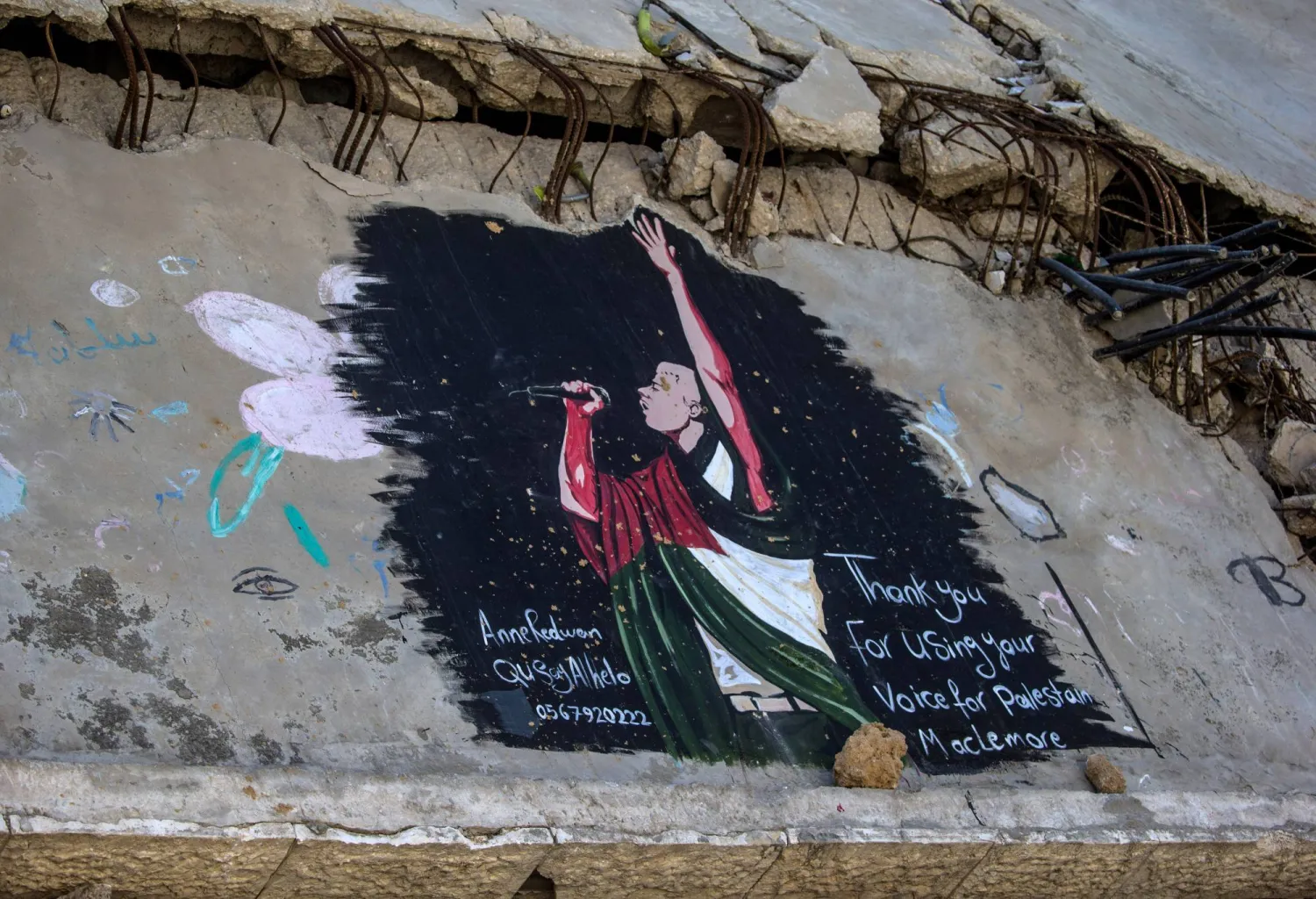 A mural by Palestinian artists depicts US rapper Macklemore on the ruins of homes in Gaza City, 19 September 2026. (EPA)
