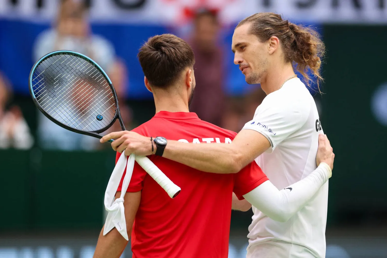 Germany's Alexander Zverev, right, after defeating Croatia's Dino Prizmic in their Davis Cup second qualifying round tennis match in Halle, Germany, Sunday, Sept. 20, 2026. (Christoph Reichwein/dpa via AP)