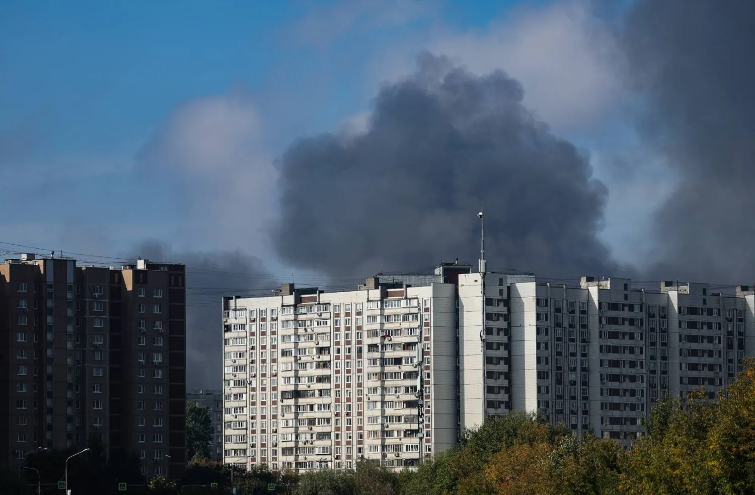 Smoke rises behind a multi-story building following a reported Ukrainian drone attack in Dzerzhinsky, Moscow region, Russia, 20 September 2026. EPA/STRINGER