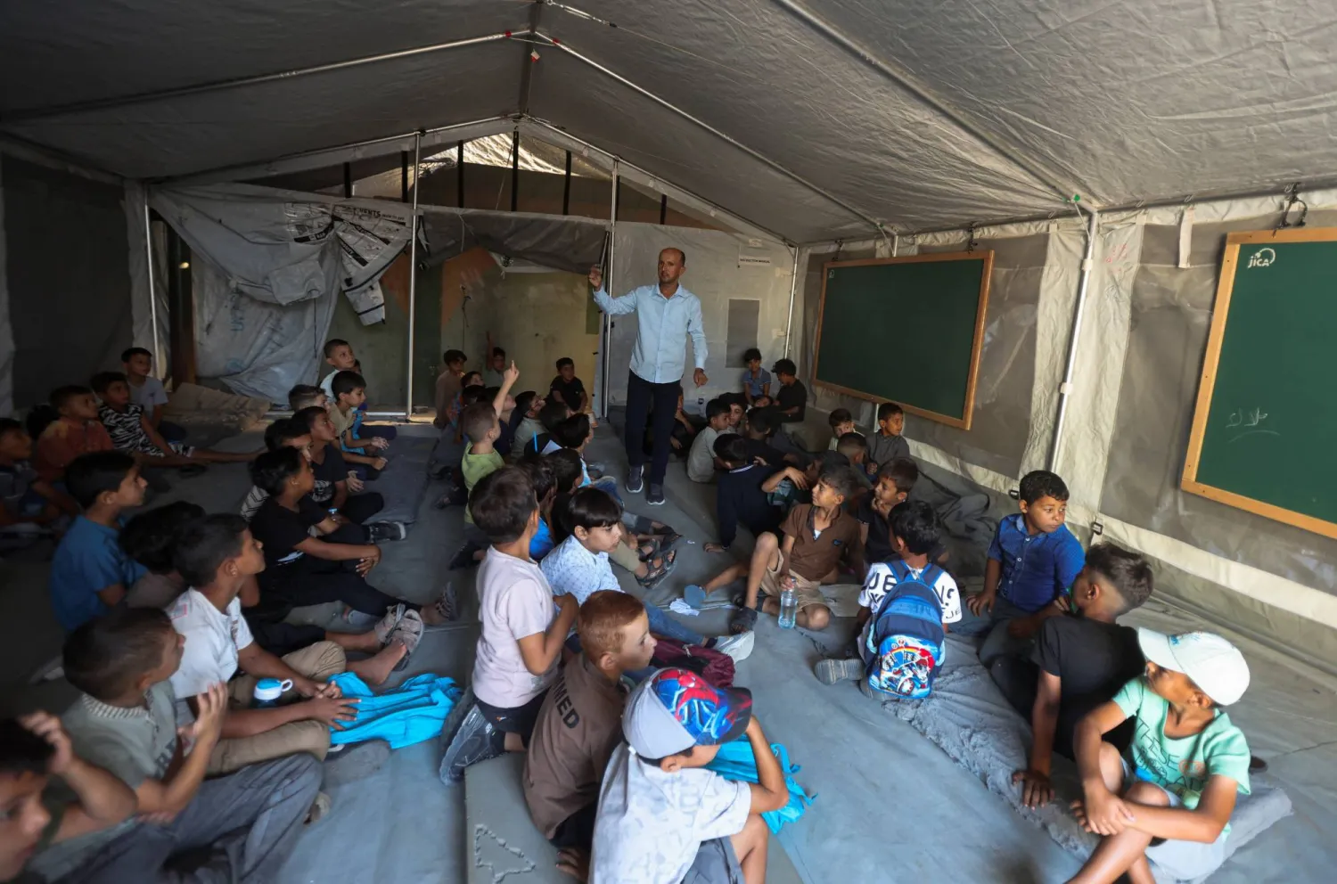 Palestinian students attend their first day of the new school year inside a tent classroom at a school in Khan Younis, in the southern Gaza Strip, September 19, 2026. (Reuters) 