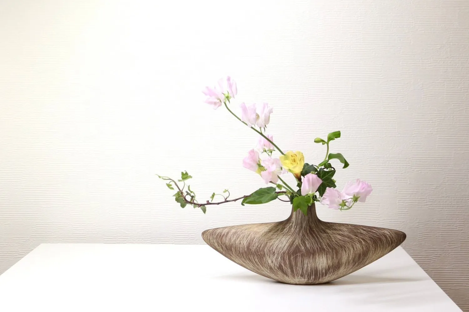 This photo released by Hiroyuki Okada shows a free-style Ikenobo ikebana arrangement in Tokyo on March 11, 2026. (Hiroyuki Okada via AP)