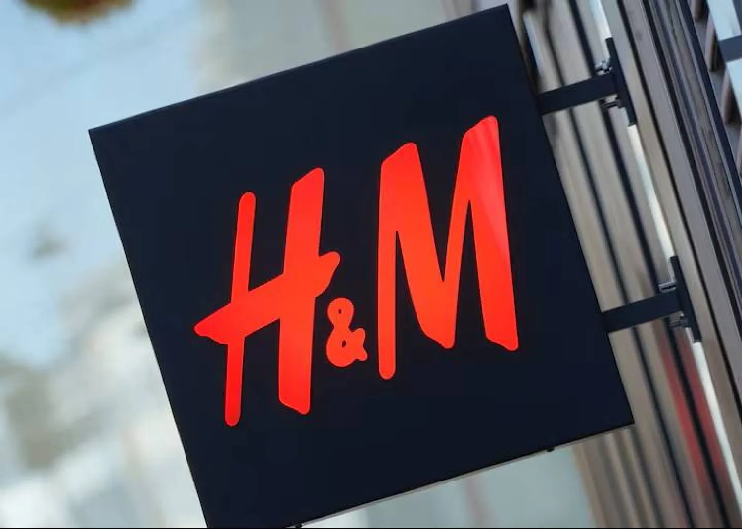 The logo for H&M is displayed outside a store in Stockholm, Sweden, September 23, 2025. REUTERS/Tom Little/File Photo 