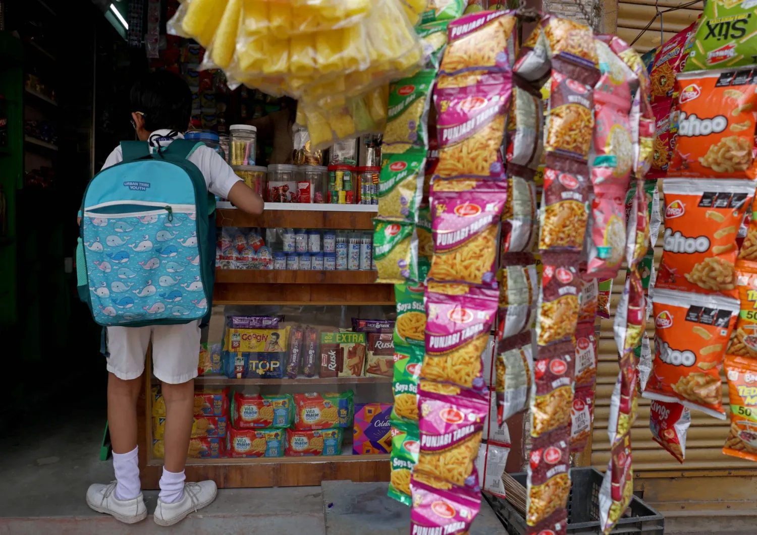 A schoolchild inside a grocery shop in Cuttack, Odisha, India, September 18, 2026. REUTERS/Priyanshu Singh
