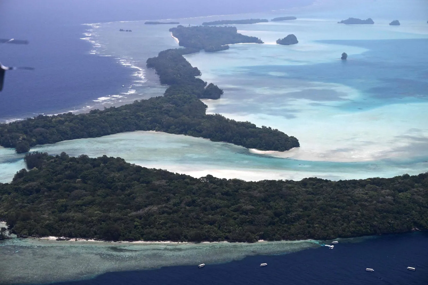 This picture taken on September 4, 2026, shows an aerial view of the small islands off the coast of Koror, the capital of Palau, scattered across the turquoise waters of the Pacific Ocean. (AFP)