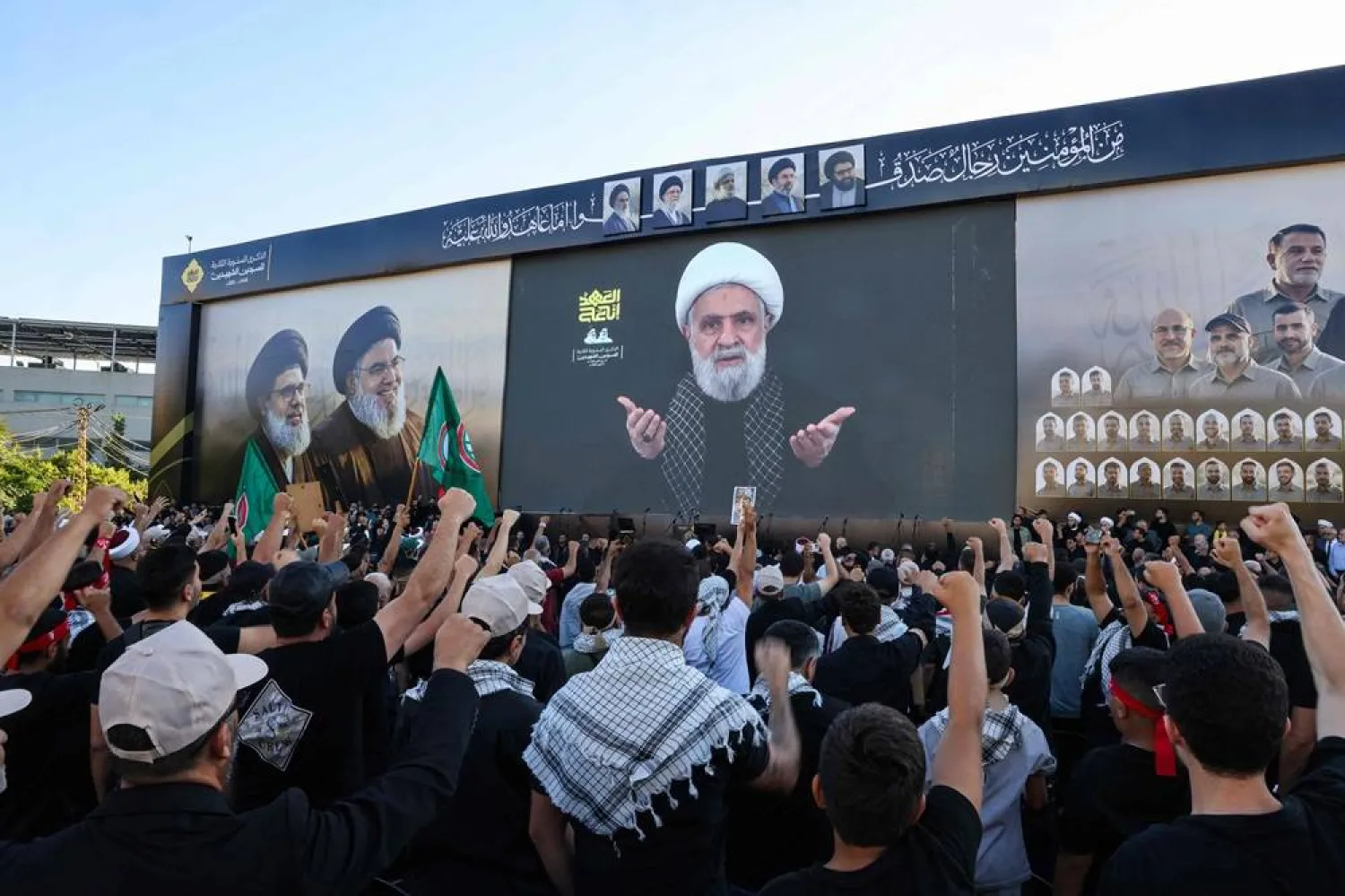 Supporters of Hezbollah shout slogans as they watch a televised speech by Hezbollah chief Naim Qassem during a ceremony held to mark the second anniversary of the killing of former leader Hassan Nasrallah in a strike by Israel, in Beirut's southern suburbs on September 27, 2026. (AFP)
