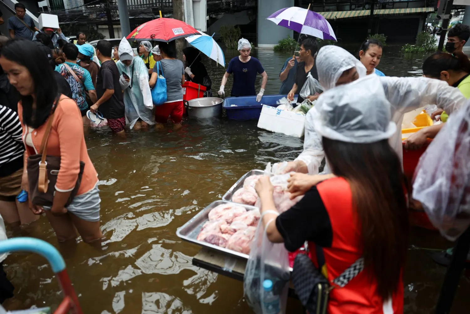 People wade through a flooded market in Bangkok, Thailand, September 28, 2026. REUTERS/Athit Perawongmetha