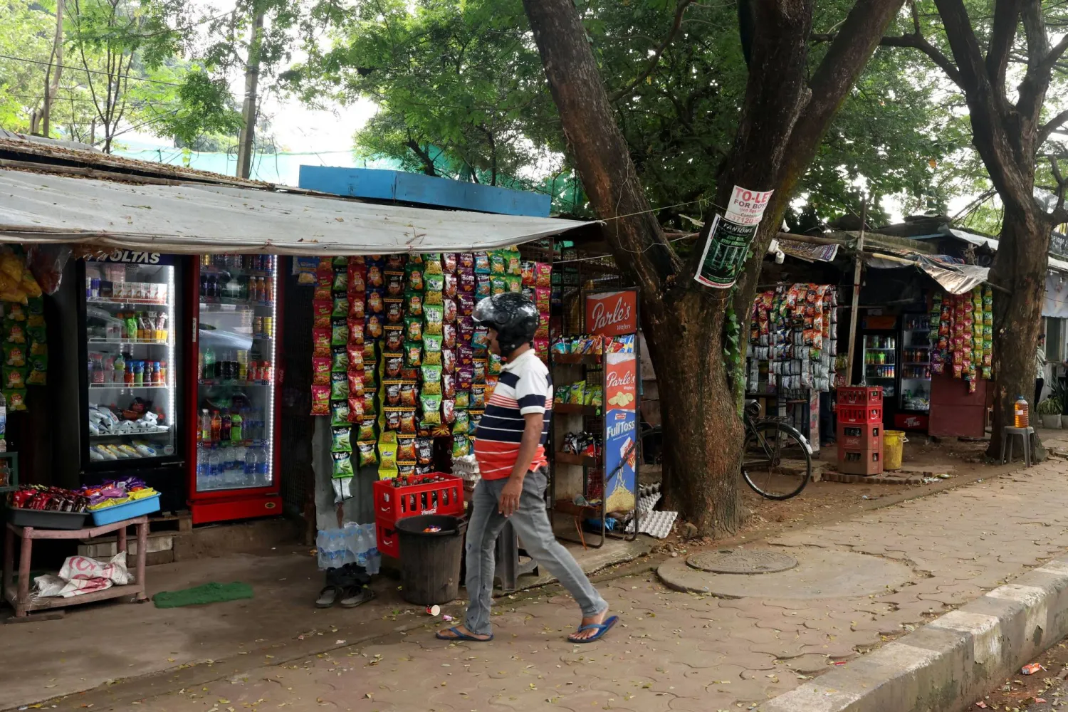 A man walks near a grocery shop in Bhubaneswar, Odisha, India, September 18, 2026. REUTERS/Priyanshu Singh