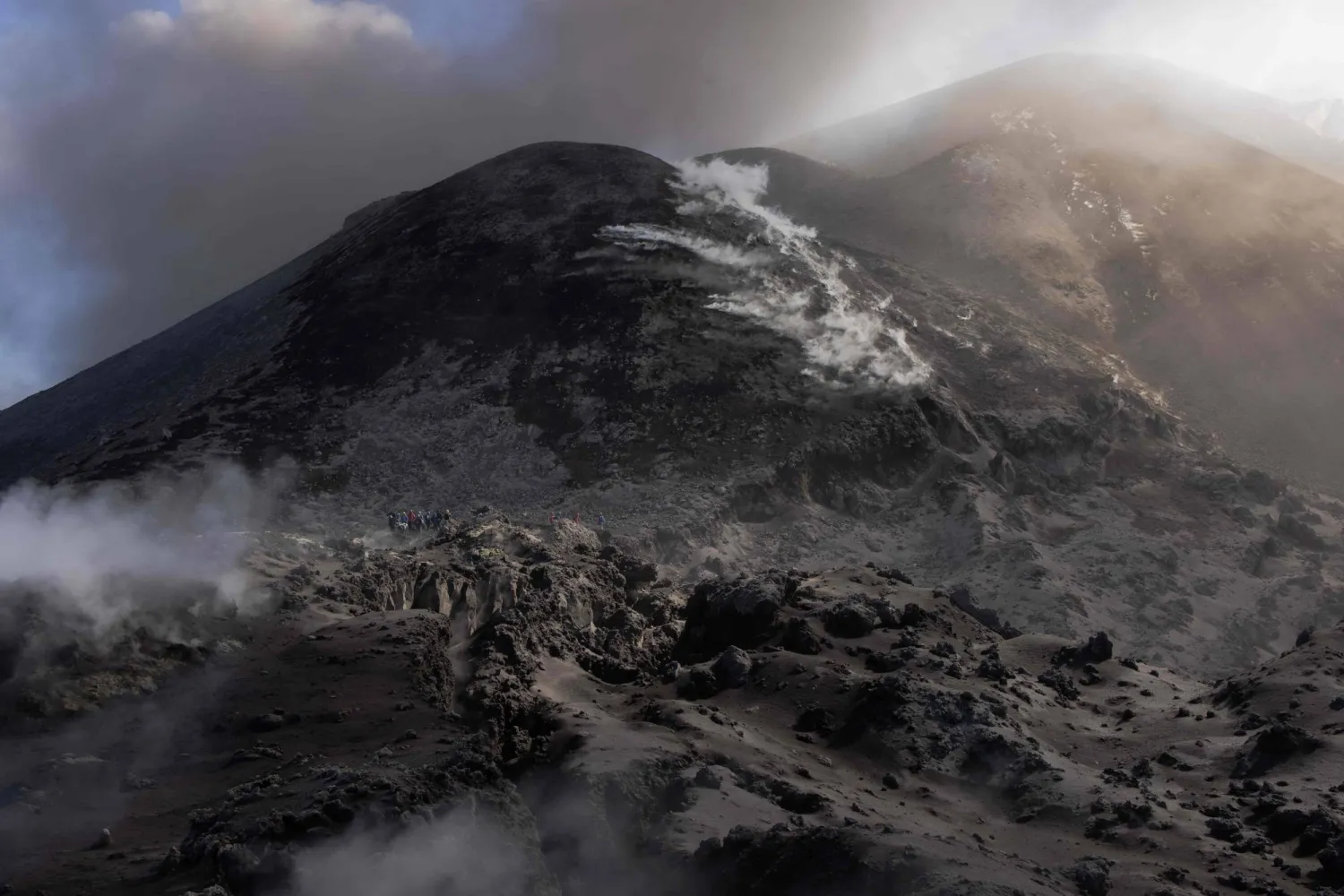 Visitors climb Mount Etna as smoke rises from its volcano in Catania, on the Mediterranean island of Sicily, on September 28, 2026. (Photo by Roman PILIPEY / AFP)