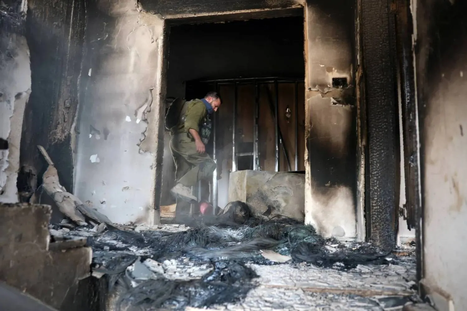  An Israeli soldier stands inside a Palestinian-owned home in the West Bank after Israeli settlers attacked and set it on fire on Tuesday. (Reuters)