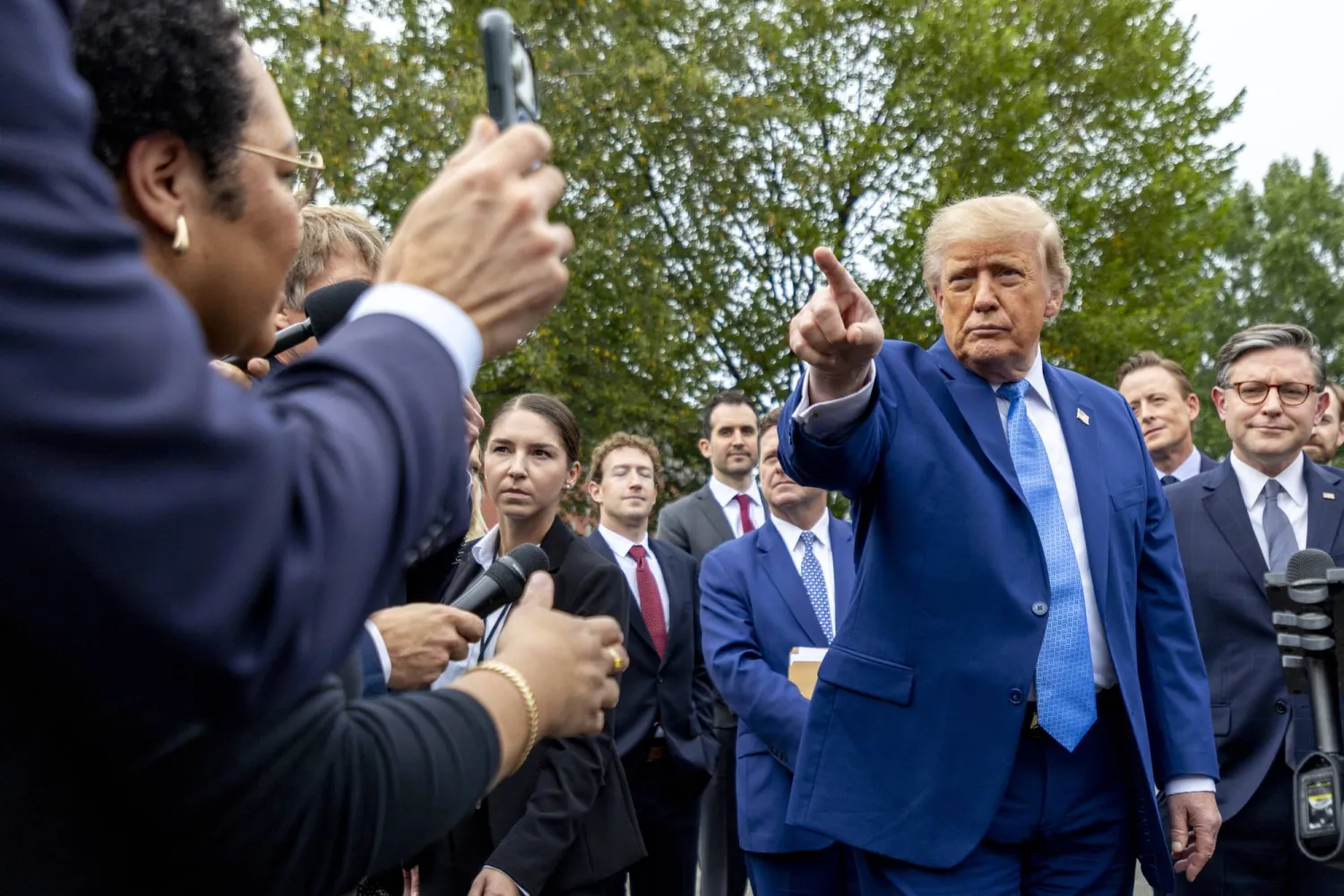 US President Donald Trump (2-R), with Speaker of the House Mike Johnson (R), responds to a question from the news media outside the West Wing of the White House in Washington, DC, USA, 29 September 2026. (EPA) 