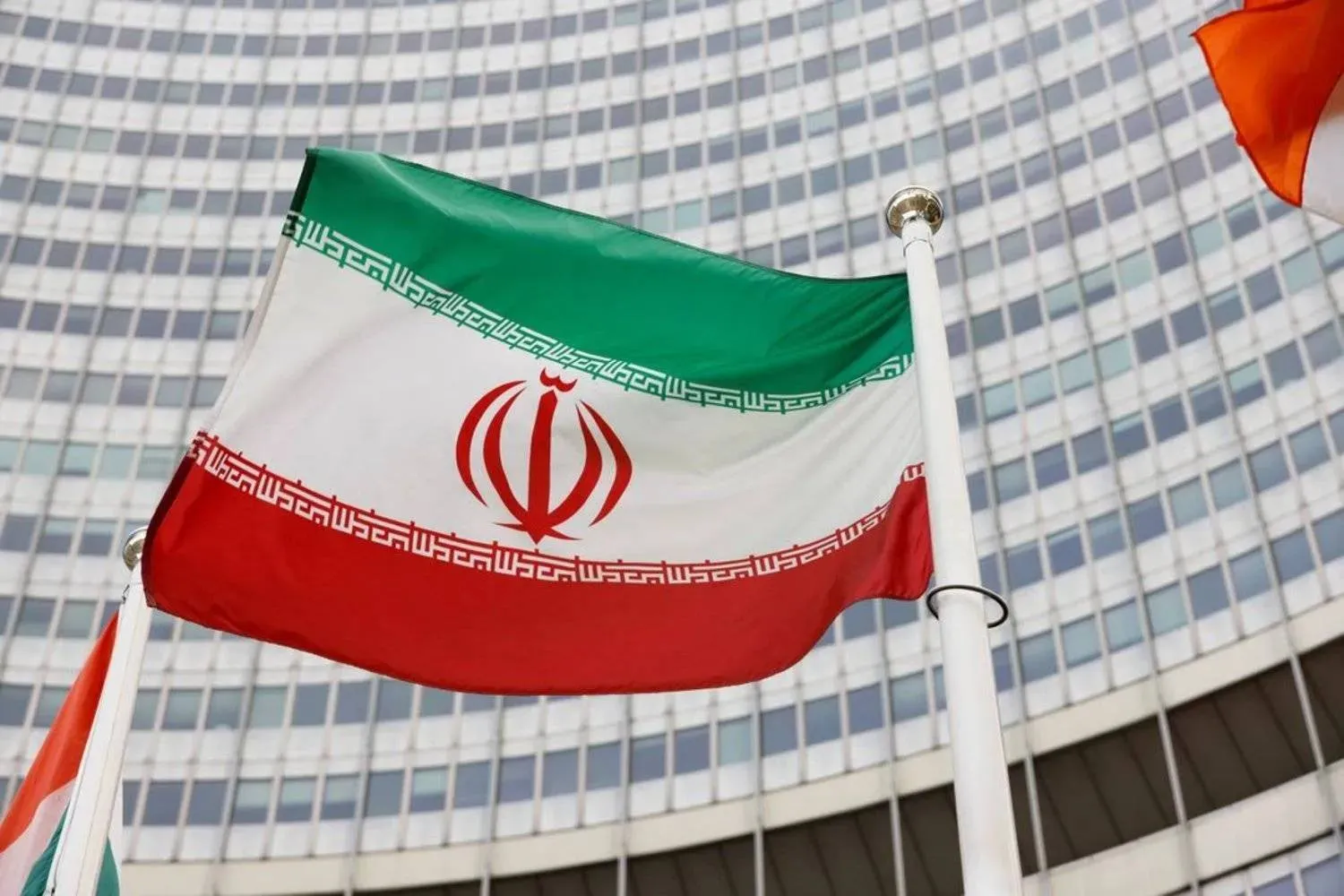 The Iranian flag waves in front of the International Atomic Energy Agency (IAEA) headquarters, amid the coronavirus disease (COVID-19) pandemic, in Vienna, Austria May 23, 2021. (Reuters)

