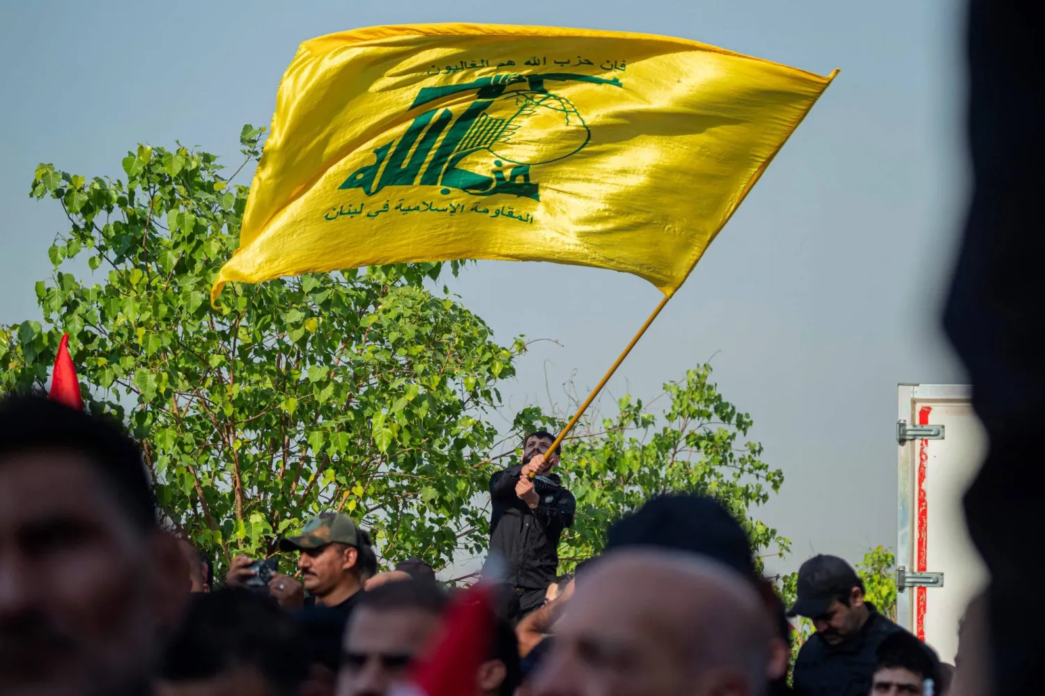 A man waves Hezbollah flag at the Tahrir Square in Baghdad on September 26, 2026, to mark the second anniversary of killing of Hezbollah's former chief Hassan Nasrallah, in a major strike by Israel on Beirut's southern suburbs in Lebanon. (AFP)