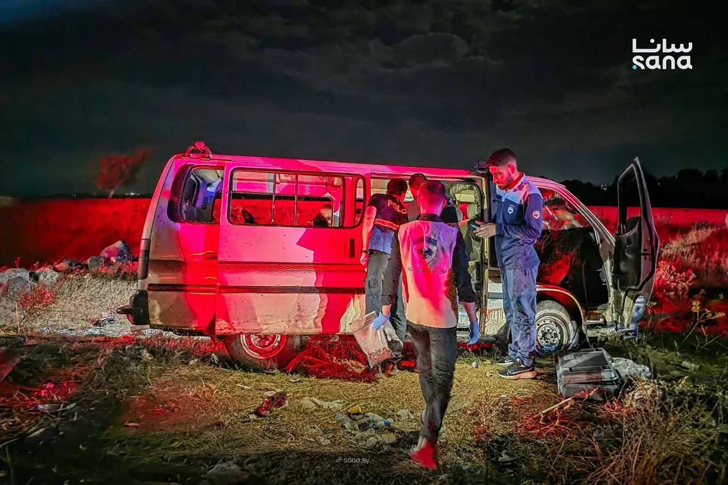 This handout photograph taken and released by the official Syrian Arab News Agency (SANA) shows Syrian forensic investigators inspecting a civilian vehicle targeted on the Masyaf bridge in Homs province north of the capital Damascus on September 30, 2026. (SANA/AFP)