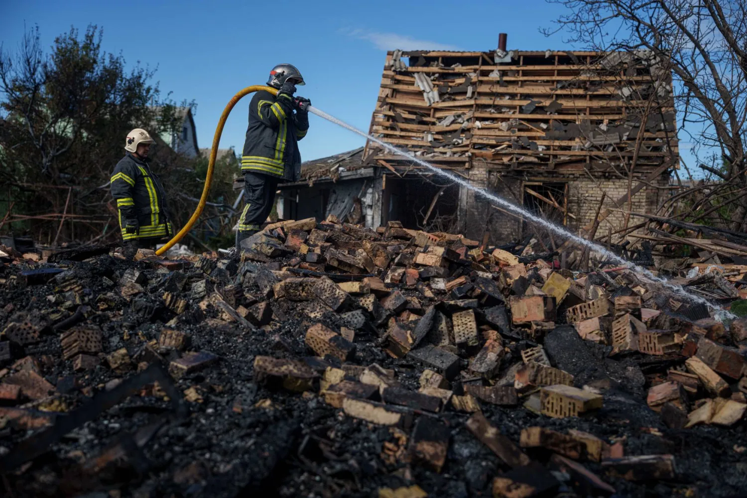  Rescue workers put out a fire at a residential house destroyed in a Russian missile strike on Vyshhorod, Kyiv region, Ukraine, Wednesday, Sept. 30, 2026. (AP) 