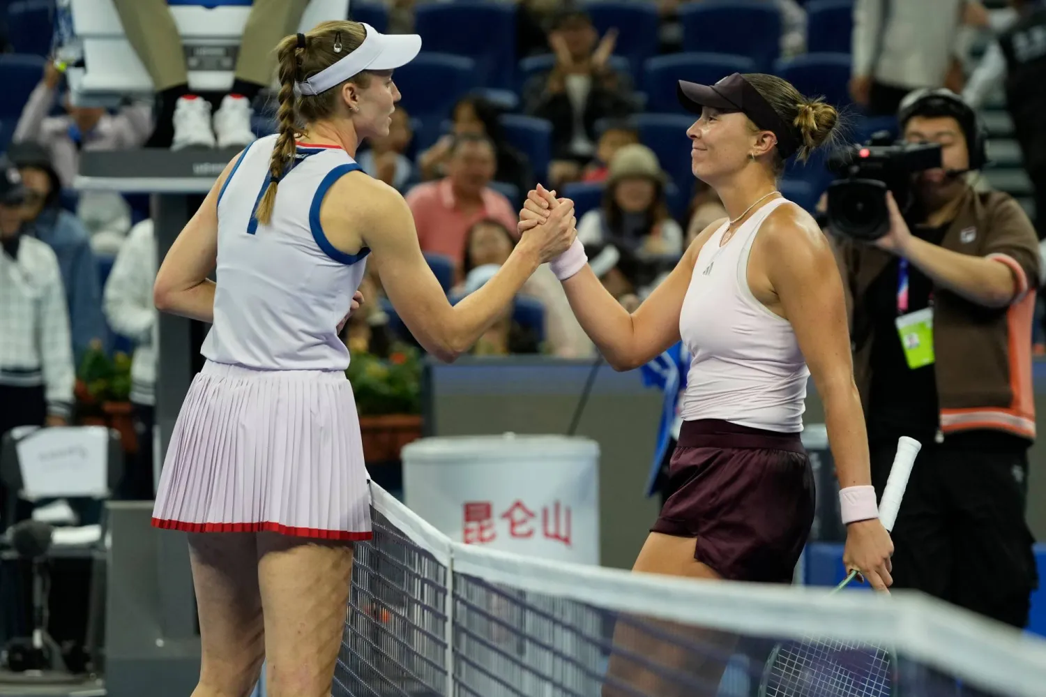 Alina Charaeva, of Russia, left is congratulated by Elena Rybakina, of Kazakhstan, after winning their women's singles second round match during the China Open tennis tournament in Beijing, Saturday, Oct. 3, 2026. (AP Photo/Ng Han Guan)