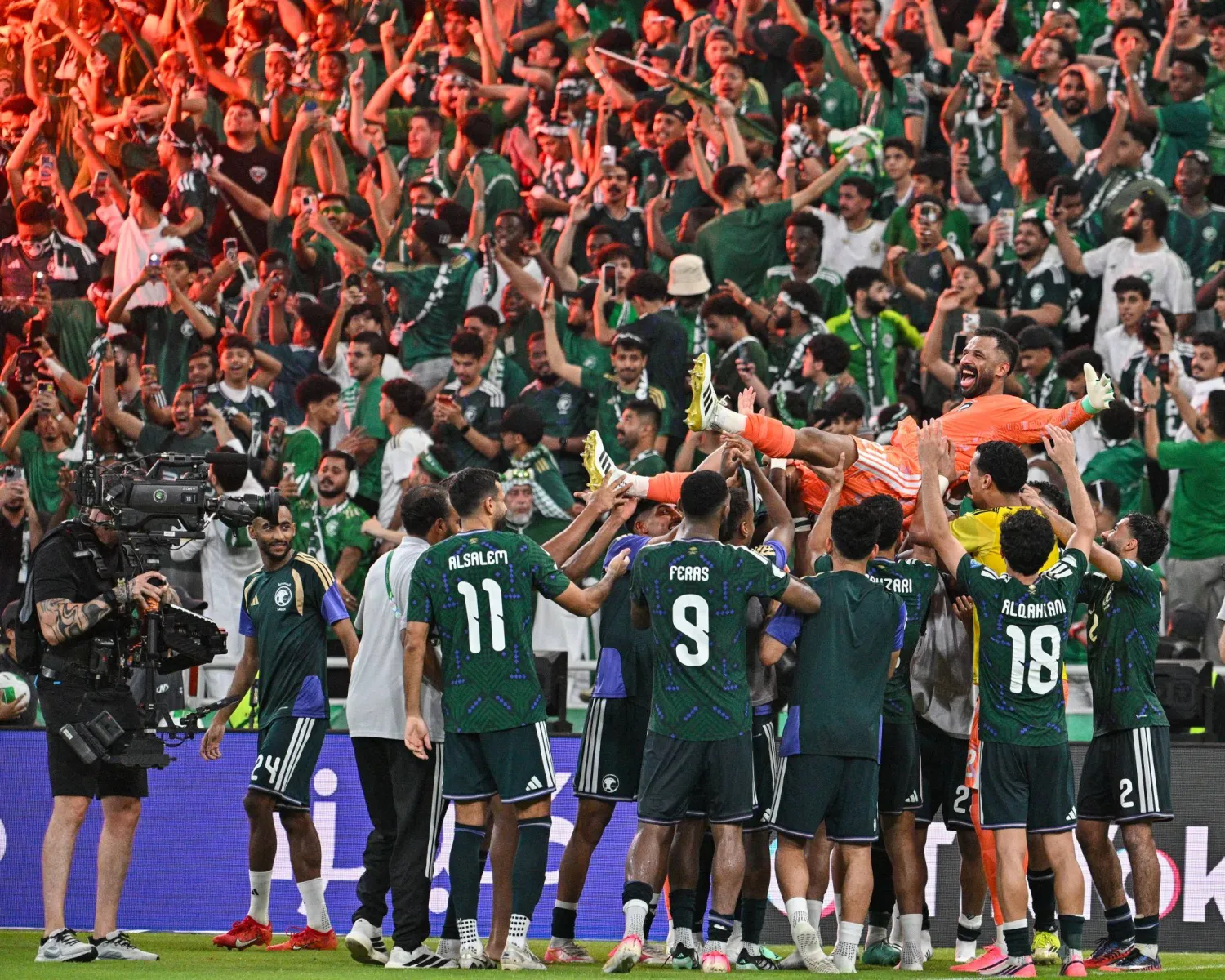 لاعبو المنتخب السعودي يحتفلون بالحارس العويس بطل ركلات الترجيح (تصوير: علي خمج)