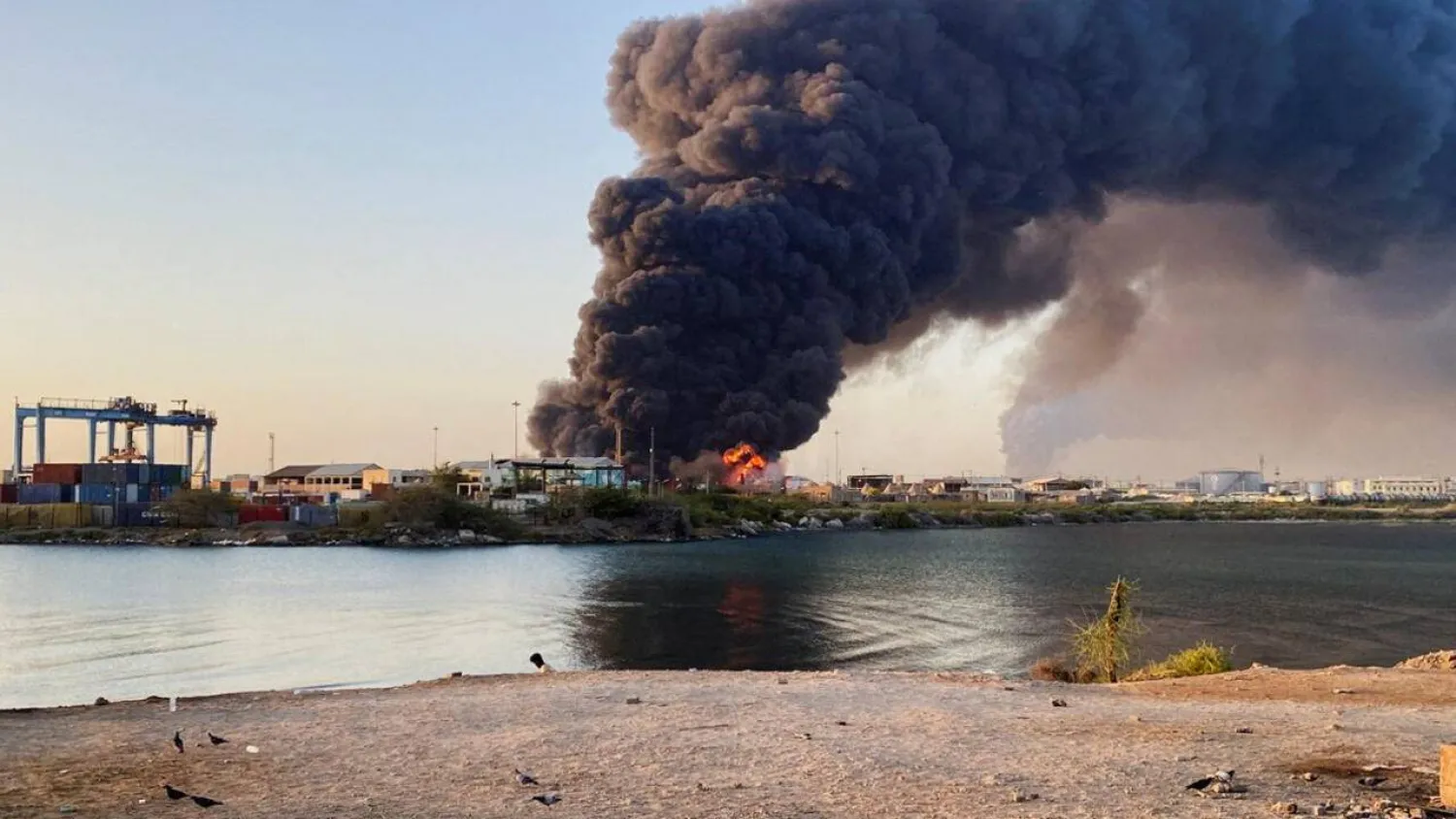 A view shows a large plume of smoke and fire rising from fuel depot in Port Sudan on May 6, 2025. (AFP)