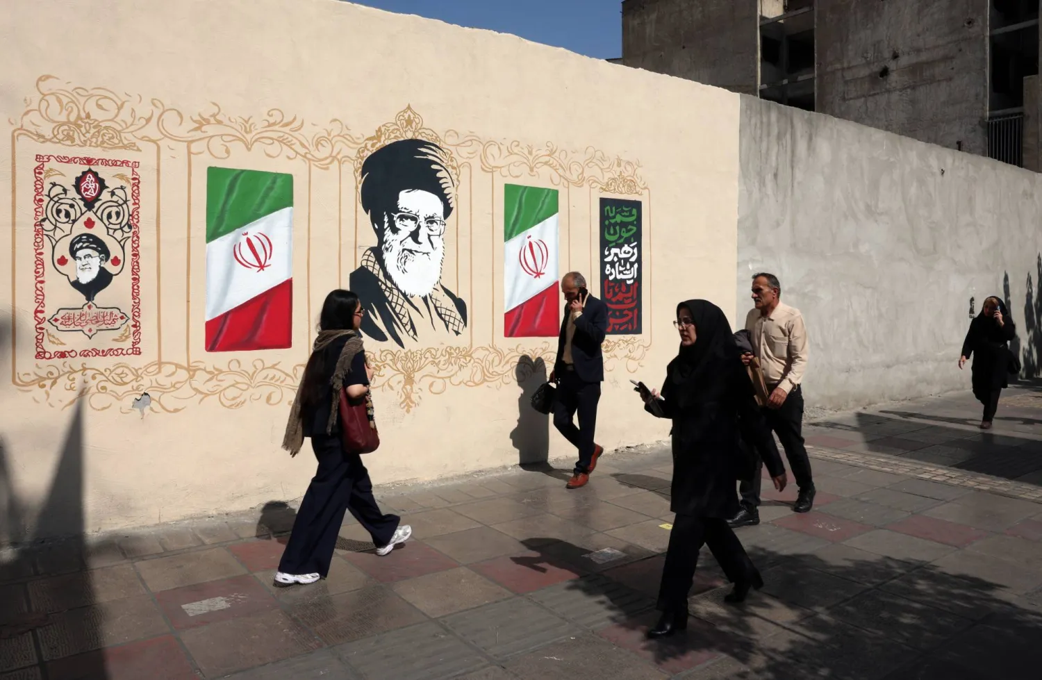 Iranians walk next to a wall painting of late Iranian Supreme Leader Ali Khamenei on a street in Tehran, Iran, 06 October 2026. (EPA)