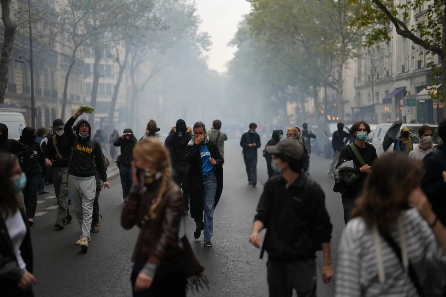 Students run through tear gas near Sciences Po university as they protest against under-resourced schools, in Paris, Wednesday, Oct. 7, 2026. (AP) 