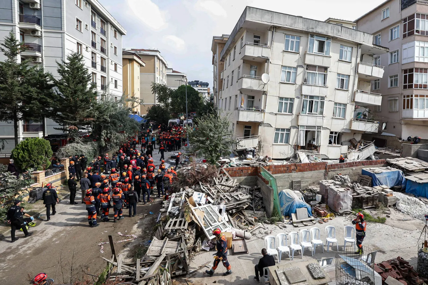 Firefighters and rescue team members work next to a partially collapsed seven story building in Istanbul, Thursday, Oct. 8, 2026. (Abdullah Tepeli/DIA Photo via AP)
