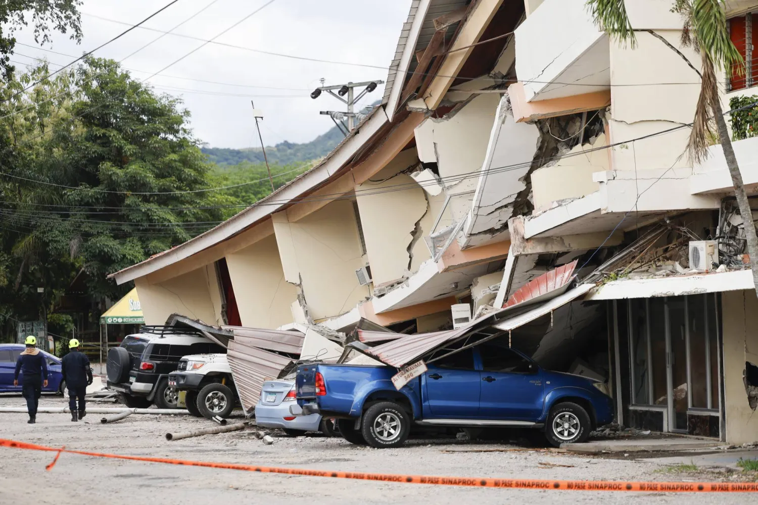 Rescue workers walk past a building damaged by the 7.7-magnitude earthquake in Panama City, Panama, 09 October 2026. (EPA)