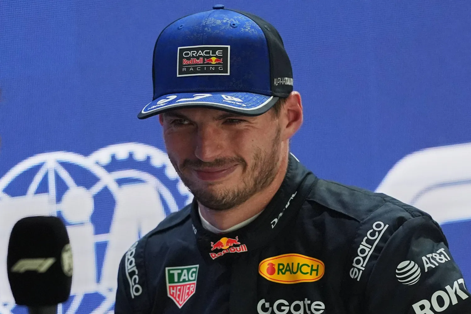 Red Bull driver Max Verstappen of the Netherlands smiles as he speaks after finishing first during the qualifying session ahead of the Singapore Formula One Grand Prix in Singapore, Singapore, Saturday, Oct. 10, 2026. (AP Photo/Ng Han Guan)