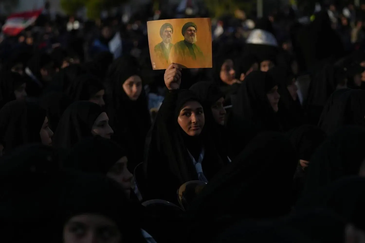 Hezbollah supporters hold up a portrait of the group’s former secretaries-general, Hassan Nasrallah and Hashem Safieddine, during the second anniversary of their assassinations in Beirut’s southern suburbs (AP). 