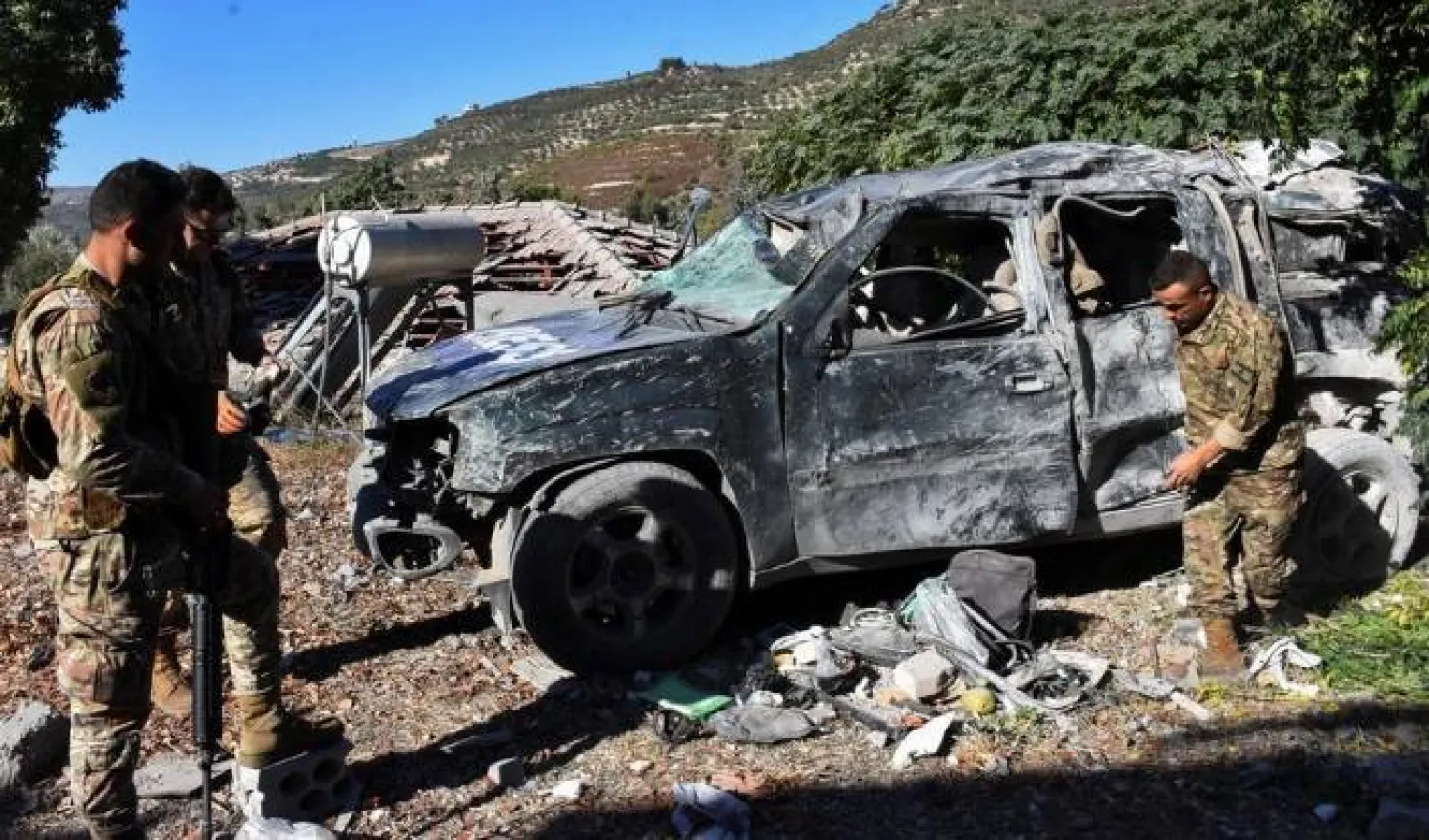 Lebanese army soldiers inspect a damaged vehicle marked with 'Press' at the site of an Israeli strike that killed a few journalists and wounded several others as they slept in guesthouses used by media, Lebanon's health ministry and local media reported, in Hasbaya in southern Lebanon, October 25, 2024. REUTERS/Stringer 