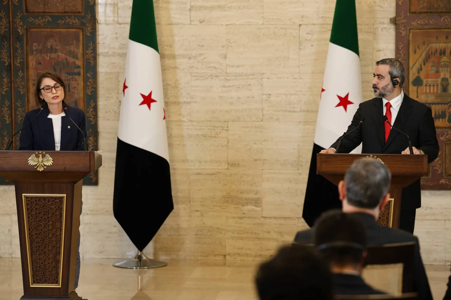 Syrian Foreign Minister Asaad al-Shaibani (R) and OPCW Director General Dallafior (L) attend a joint press conference at the Tishreen Palace in Damascus, Syria, 13 October 2026. (EPA)