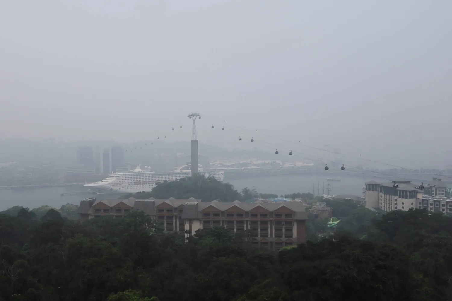 Singapore cable cars travelling towards Mount Faber station are shrouded in haze as smoke from regional forest fires reduces visibility across the city-state, in Singapore, October 14, 2026. REUTERS/Suhaimi Abdullah