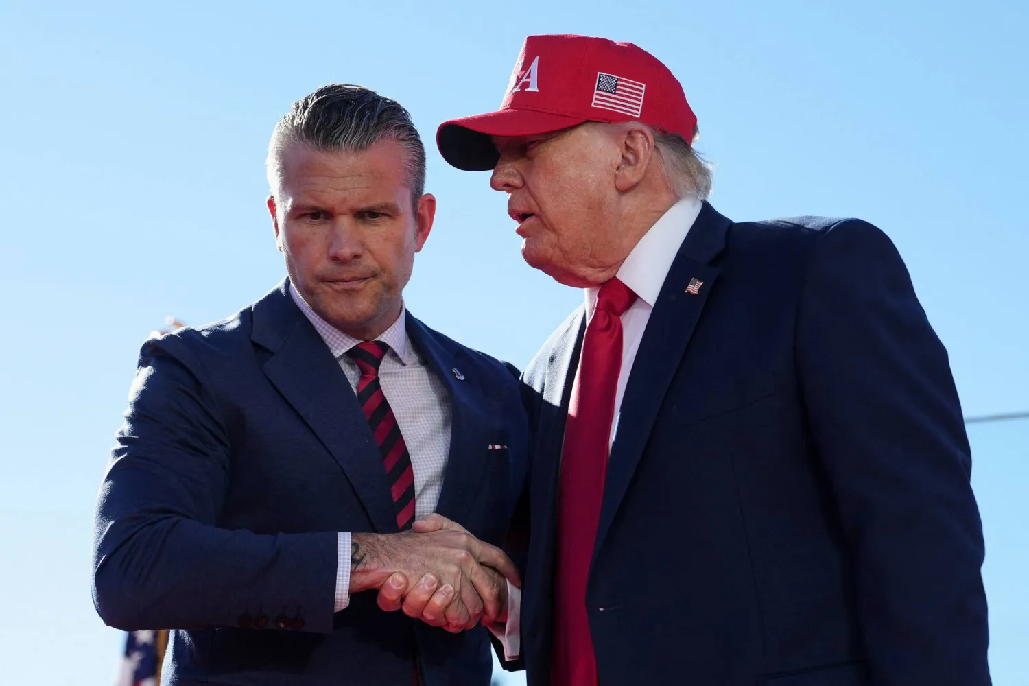  US Defense Secretary Pete Hegseth shakes hands with US President Donald Trump onstage during an event at Sparrows Point Shipyard, in Baltimore County, Maryland, US, October 6, 2026. (Reuters)