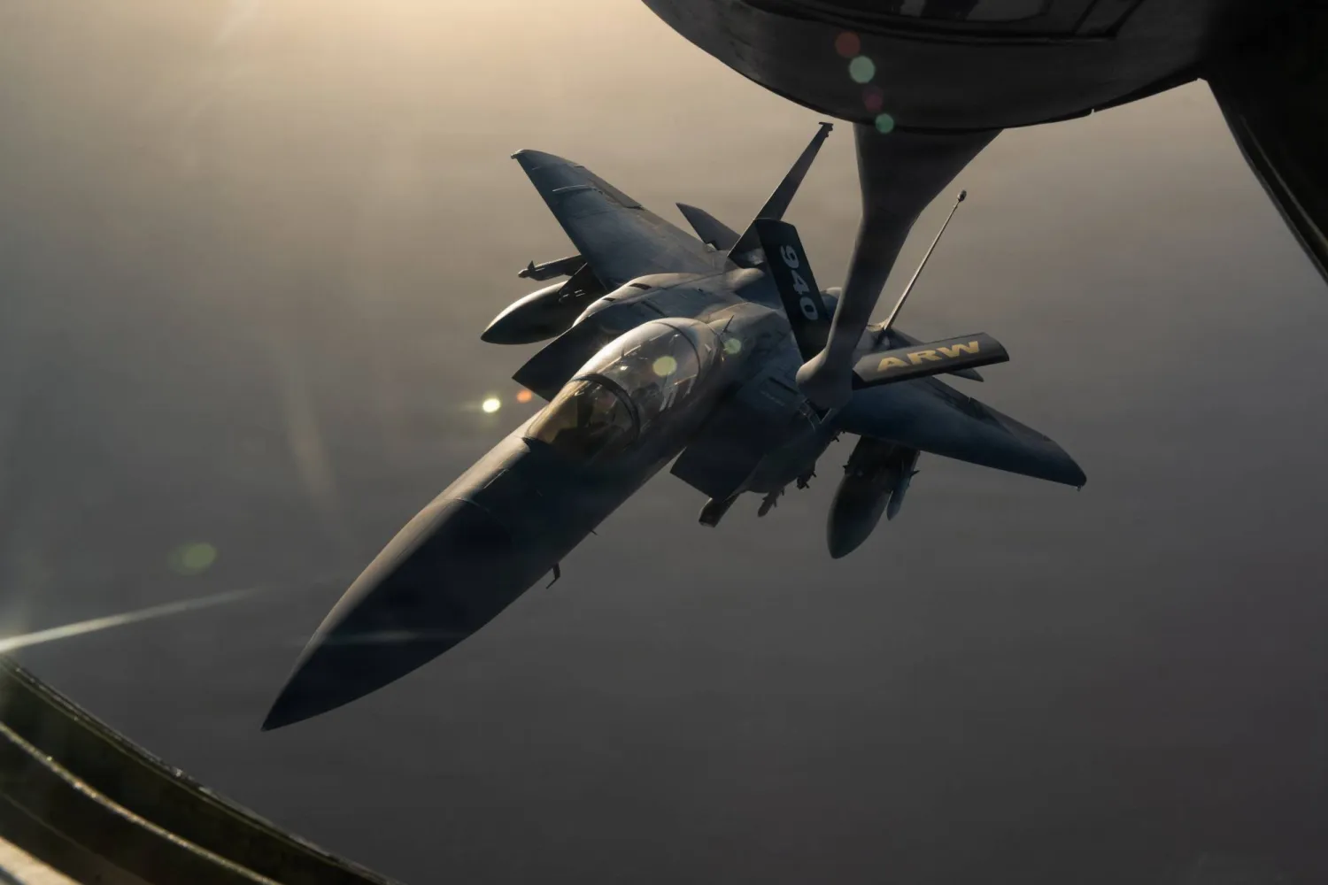 A US F-15E Strike Eagle fighter jet refuels from a KC-135 tanker aircraft during an aerial patrol over the Middle East (CENTCOM)